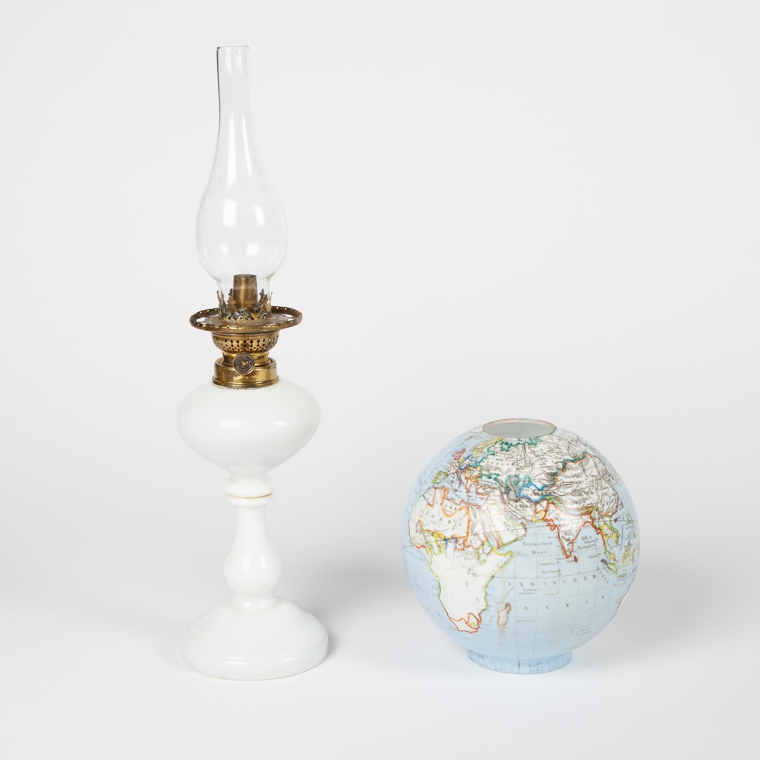 A late 19th century opalescent glass oil lamp with an illuminating globe shade, Bohemia, circa 1885.

Countries and Seas indicated in German.

Made by Stelzig, Kittel & Co.

Marked Patent No.34409. (Stelzig, Kittel & Co,