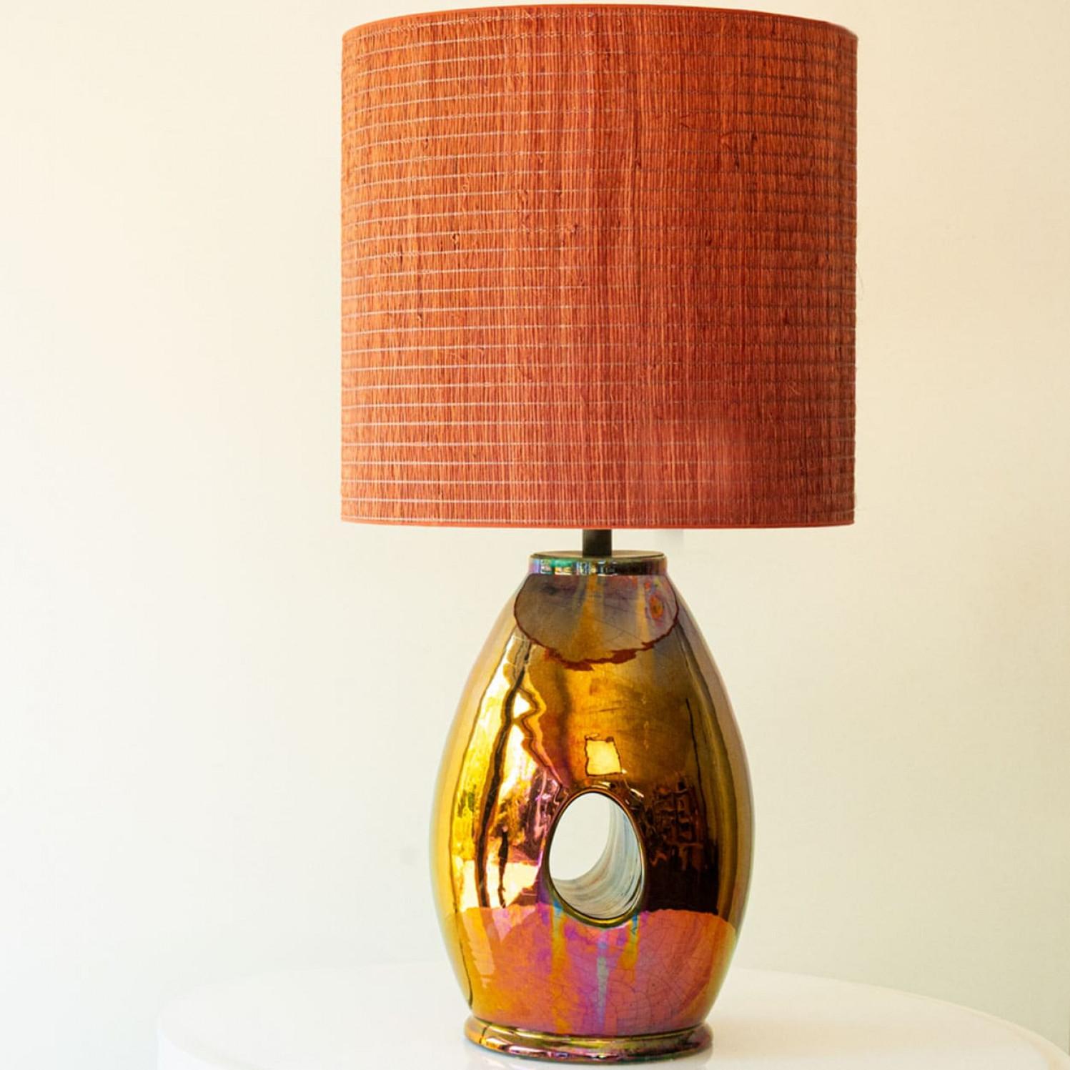 Heavy quality table lamp, 1970s.

This lamp base brings refined elegance and rich visual appeal to any interior. With its beautiful shape and materials, it offers a unique presence.

This oil look multicolor base with a hole in the middle fits