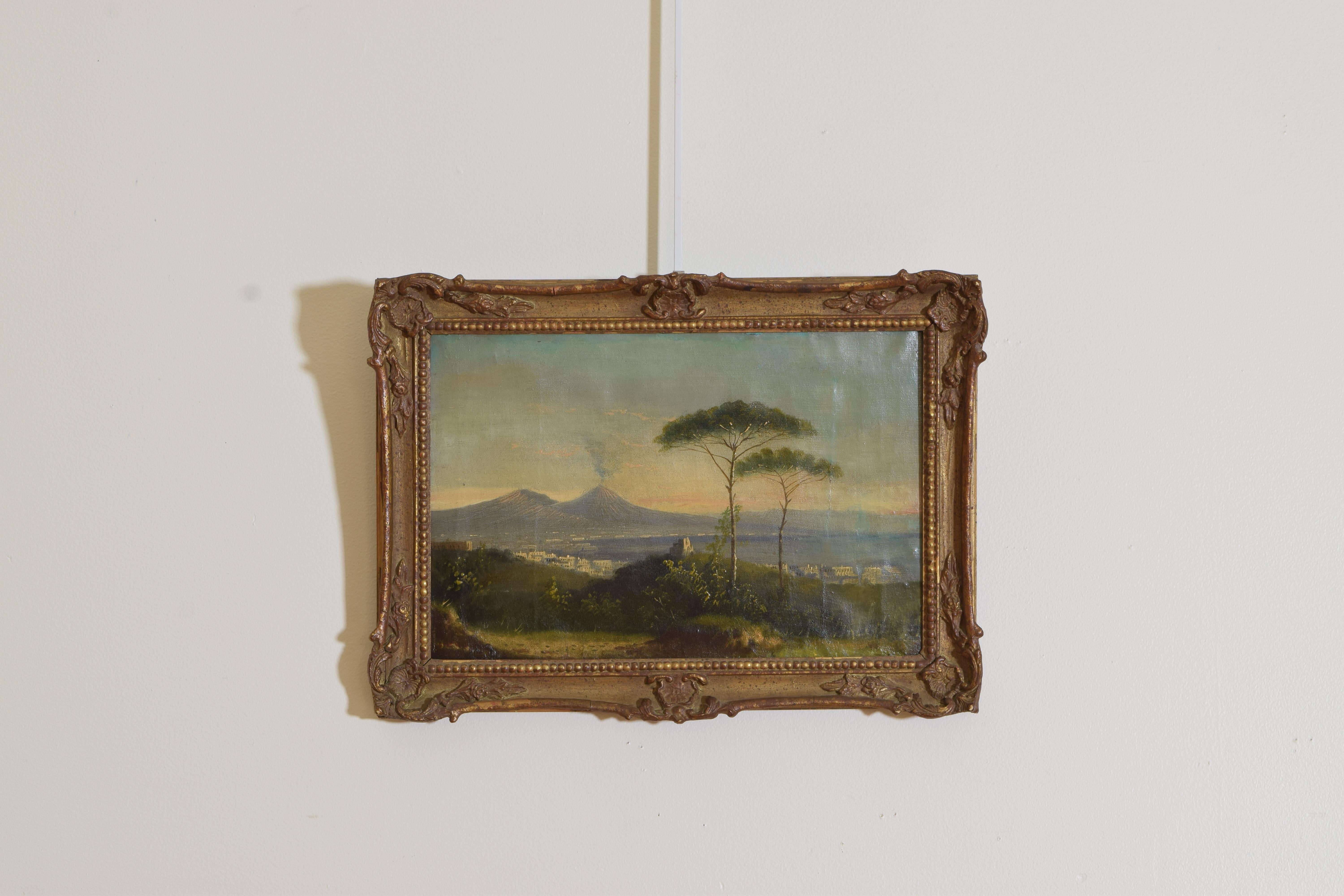 This oil painting depicts a smoking Mt. Vesuvius with the famous Pine of Naples in the foreground, artist Donald Stewart, in antique carved giltwood frame.