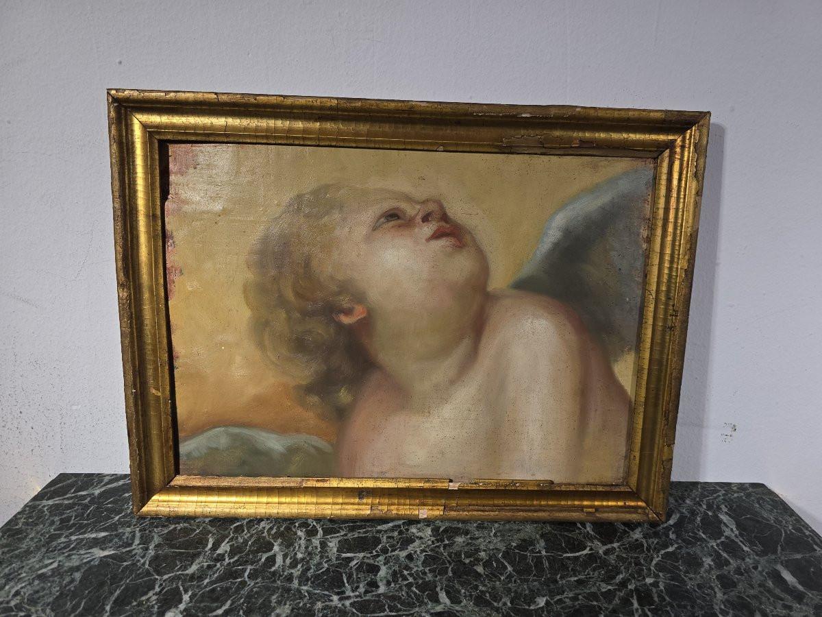 Charming oil painting depicting a cherub gazing heavenward, typical of 18th-century Baroque religious iconography. Executed on a wooden panel, this work features a beautiful softness in the sculpting of the face and a luminous palette of pastel