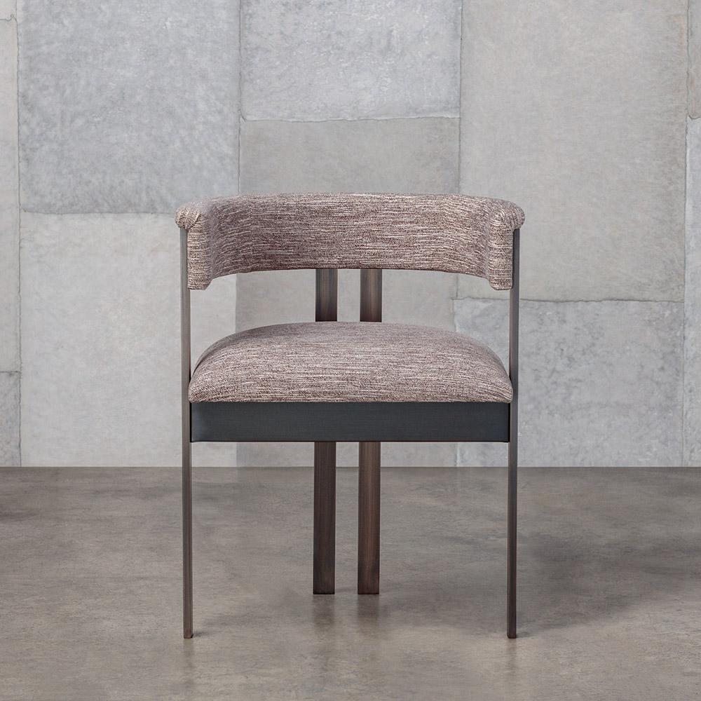 The iconic Elliot chair combines clean lines with classic vernacular. This dining or occasional chair features paired brass bar-stock legs finished in either a burnished brass or oil rubbed brass finish.