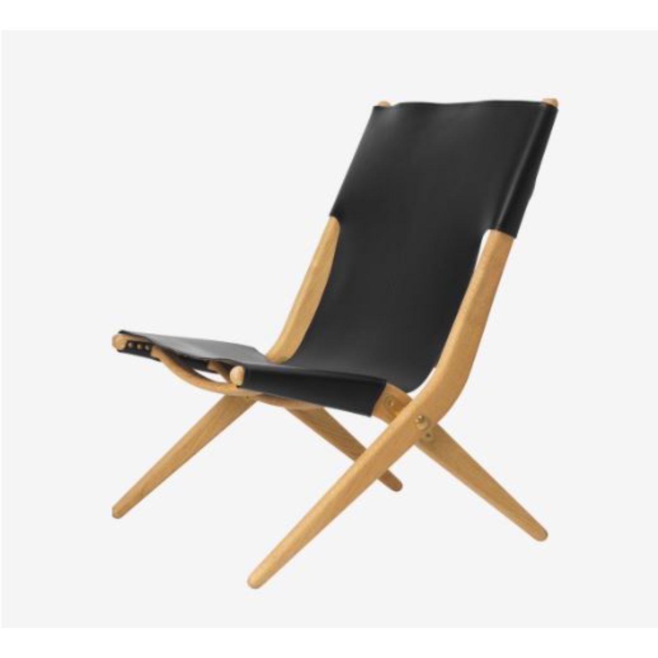 Oiled oak black leather saxe chair by Lassen
Dimensions: D 67 x W 60 x H 84 cm 
Materials: Leather, Wood, Oiled Oak
Also available in different colors and materials.
Weight: 13 Kg

Mogens Lassen was perceived as ‘the naughty boy in class’, but