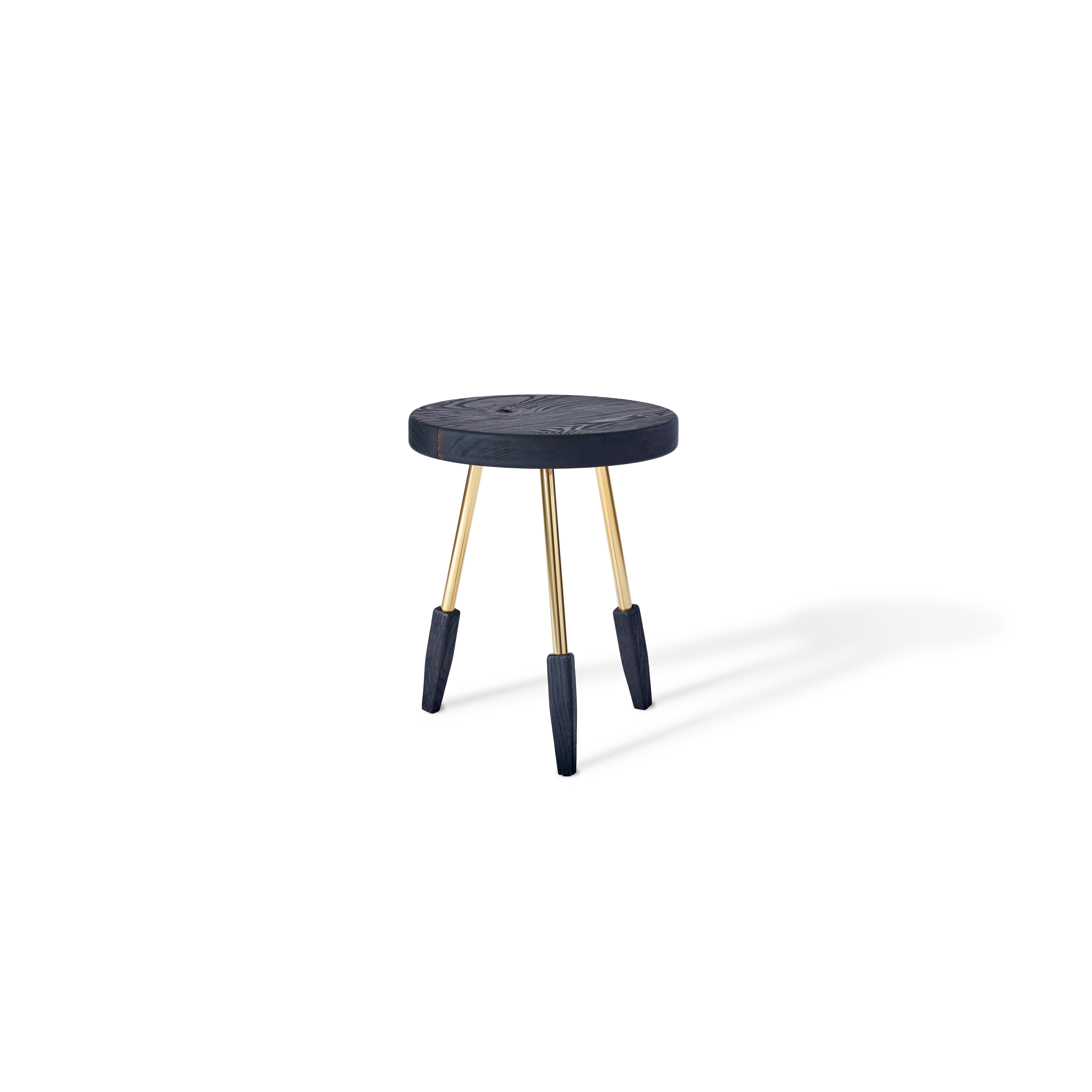 Milking stool with polished solid brass legs. Made in the USA by Casey McCafferty.

Image 1 shows oiled walnut
Image 2 shows charred ash
Image 3 shows oiled white oak 
Image 4 shows bleached white oak.

Available finishes:
Oiled black
