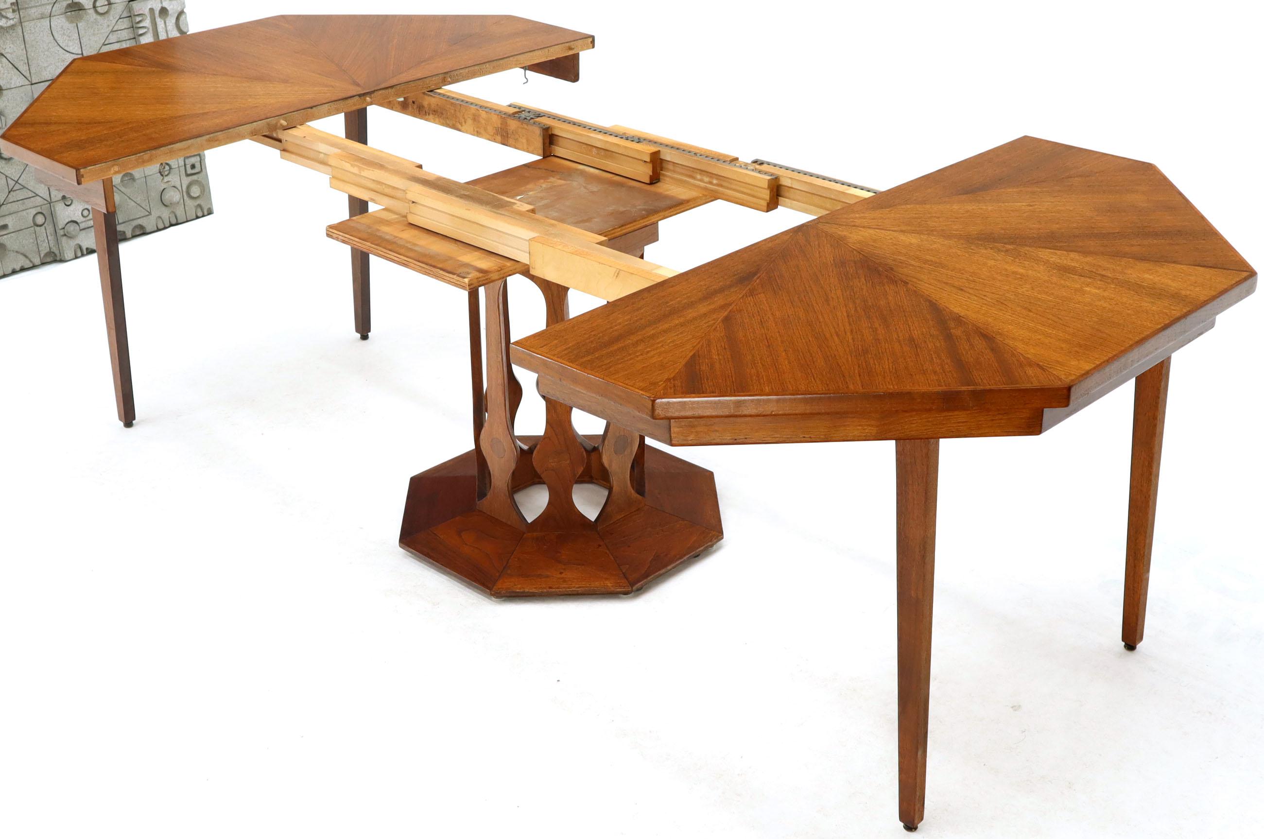 Mid-Century Modern single pedestal oiled walnut dining centre table of Harvey Probber influence. Includes two 16