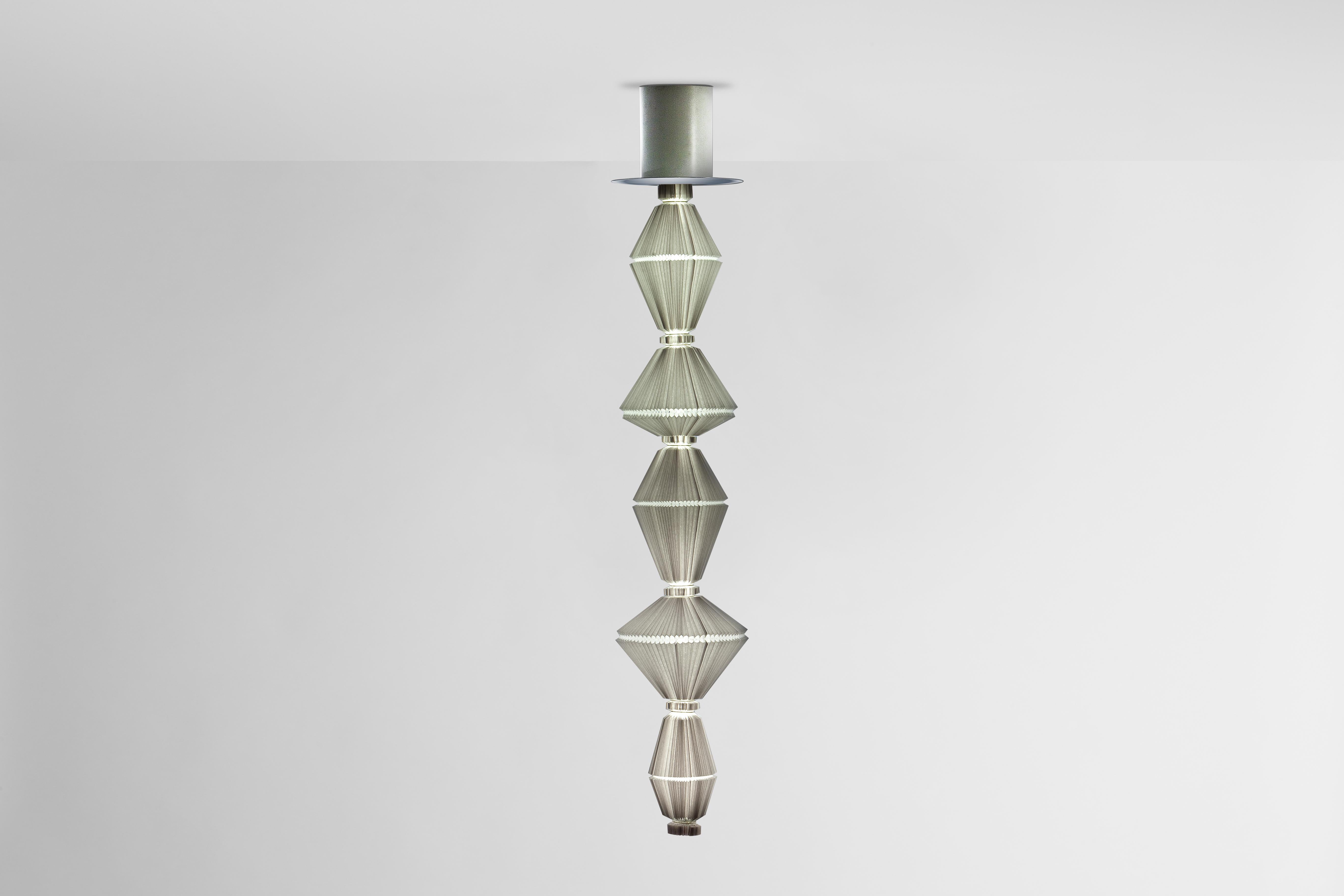 Oiphorique T PE Suspension Lamp designed by Atelier Oi in 2014.
Manufactured by Parachilna (Spain)

Oïphorique displays an elegant textile diffuser. After turning on the light you awake the soul, it all starts moving in a hypnotising