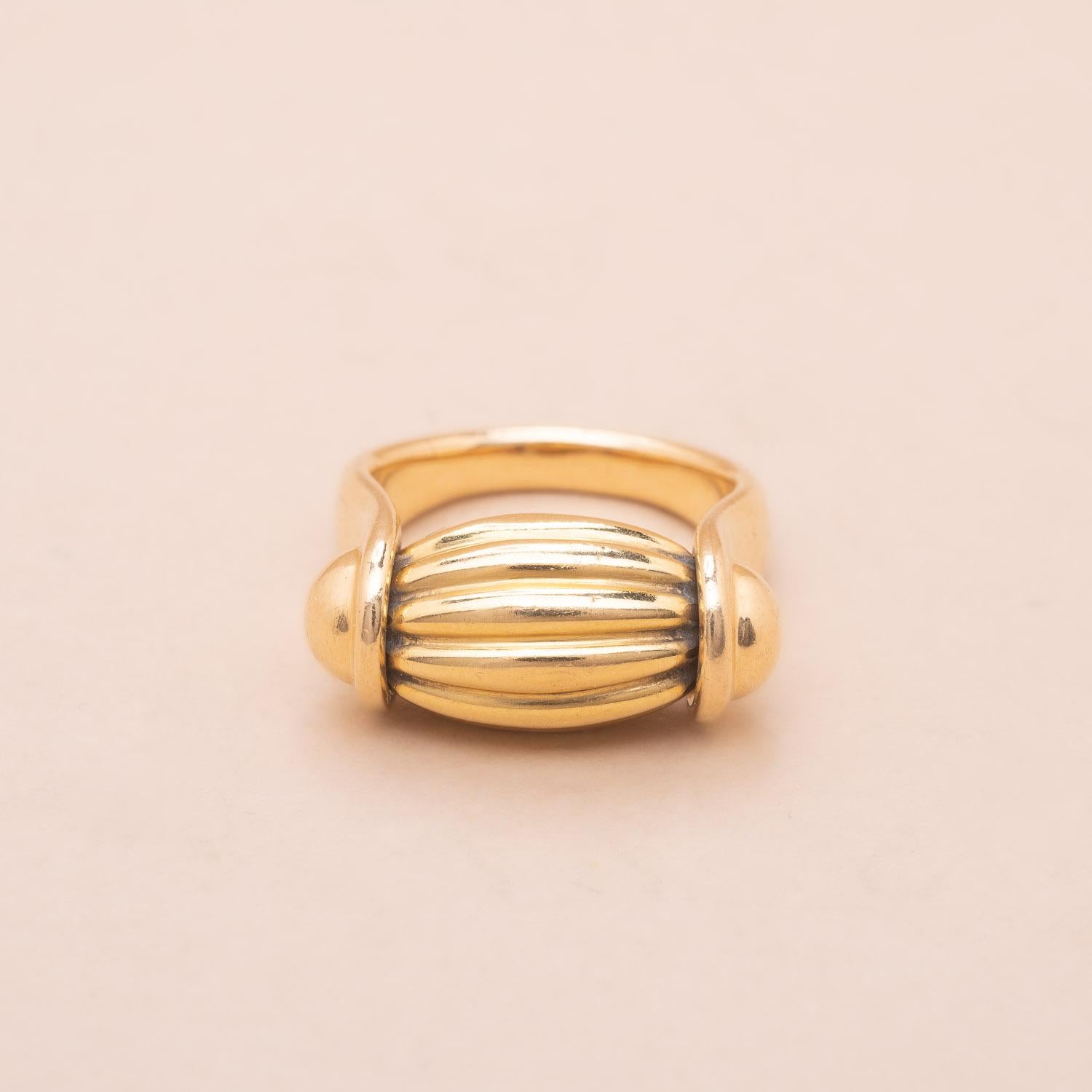 Attributed to OJ Perrin. 18K gold large band and mobile and gadrooned design ring. 
1990s French craftsmanship 
Partly erased signature 
Ring size : 54/55 FR 
Gross weight : 14.02g 
Founded in 1947 the OJ Perrin label evolved along with the biggest