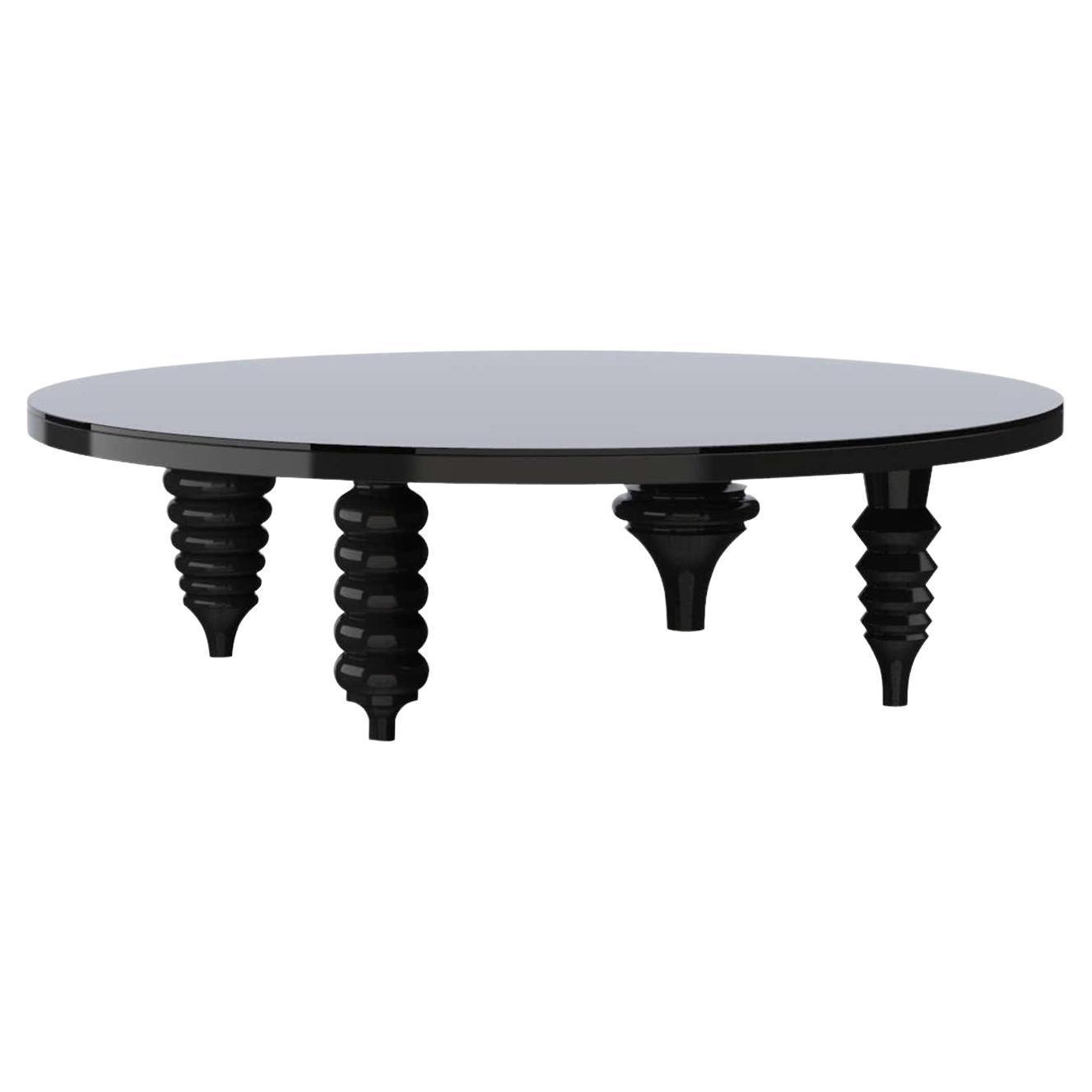 Table basse noire à pieds multiples et brillante avec plateau en verre