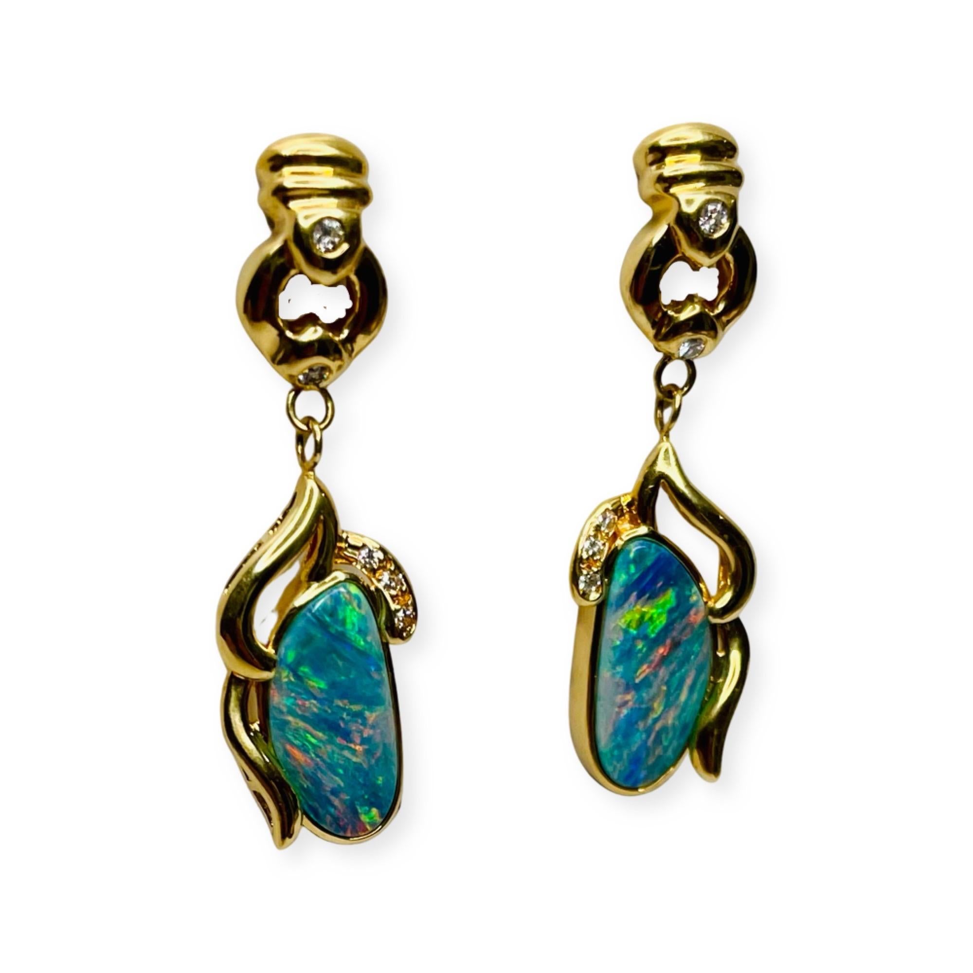Okada 18K Yellow Gold Opal Doublet Diamond Earrings. There is a total opal doublet weight of 4.92 carats. They measure 21.0 mm x 12.0 mm. The opal is bezel set. There are 6 full cut round brilliant diamonds of SI clarity and GH color. There are 3
