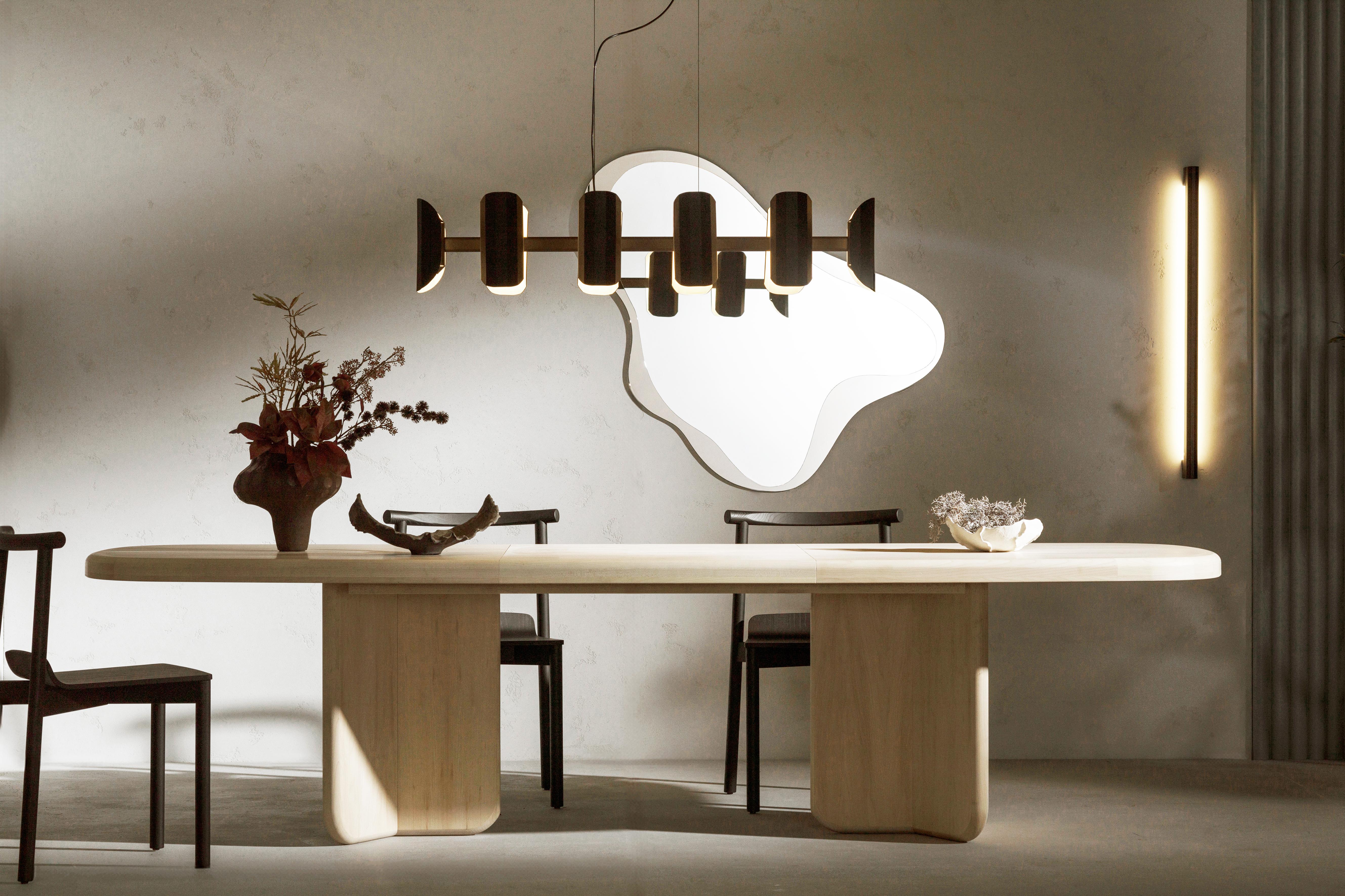Contemporary extendable dining table in oak, maple, or walnut — inspired by 1930s modernist architecture.

The Okal table is a sculptural and versatile dining piece that blends classic inspiration with modern craftsmanship. Designed by Magdalena