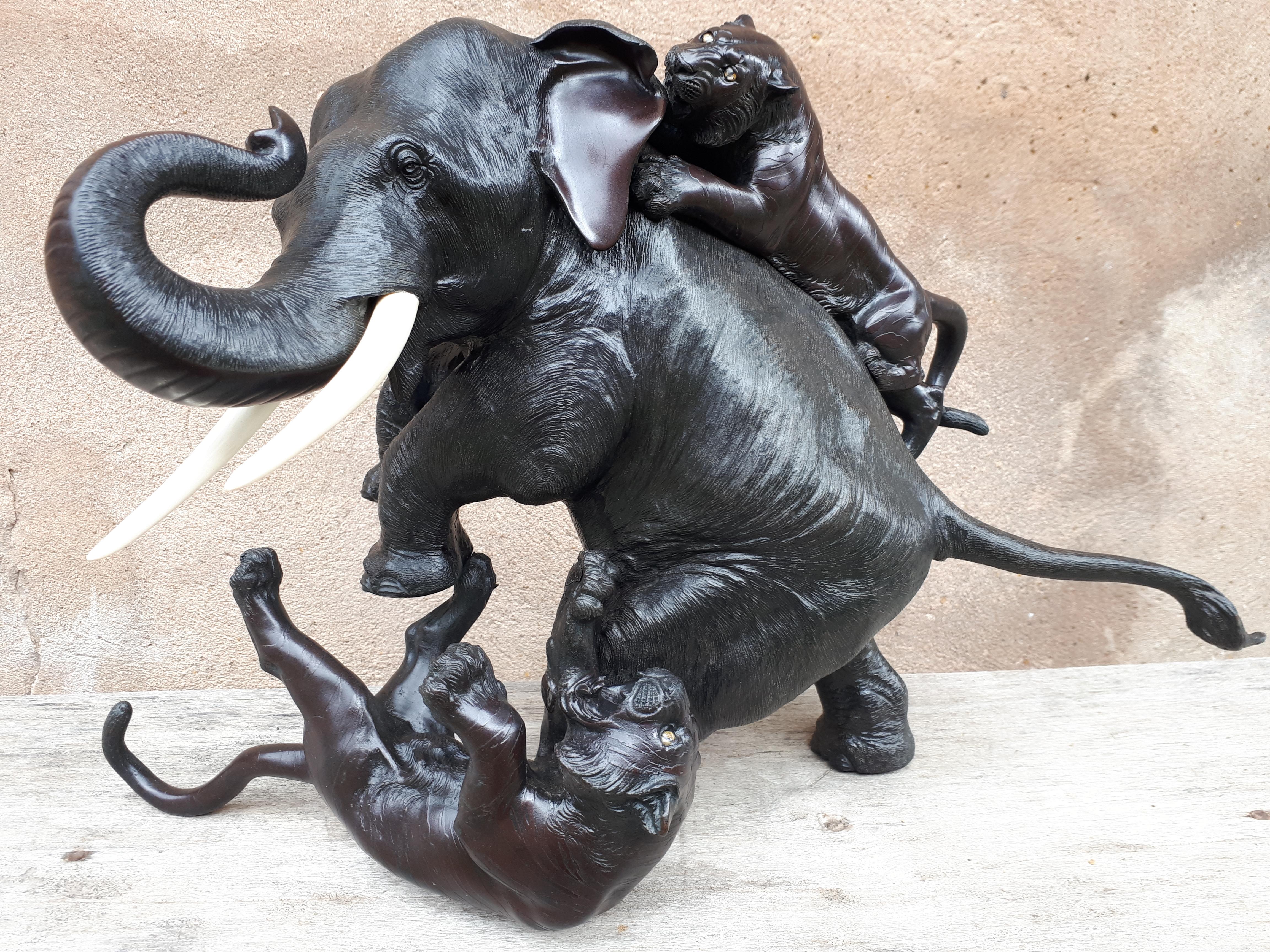 Magnificent composition for this bronze okimono with double patina representing an elephant attacked by two tigers. The skins of the different animals are rendered with great detail and with distinct techniques, including the hidden parts, notably