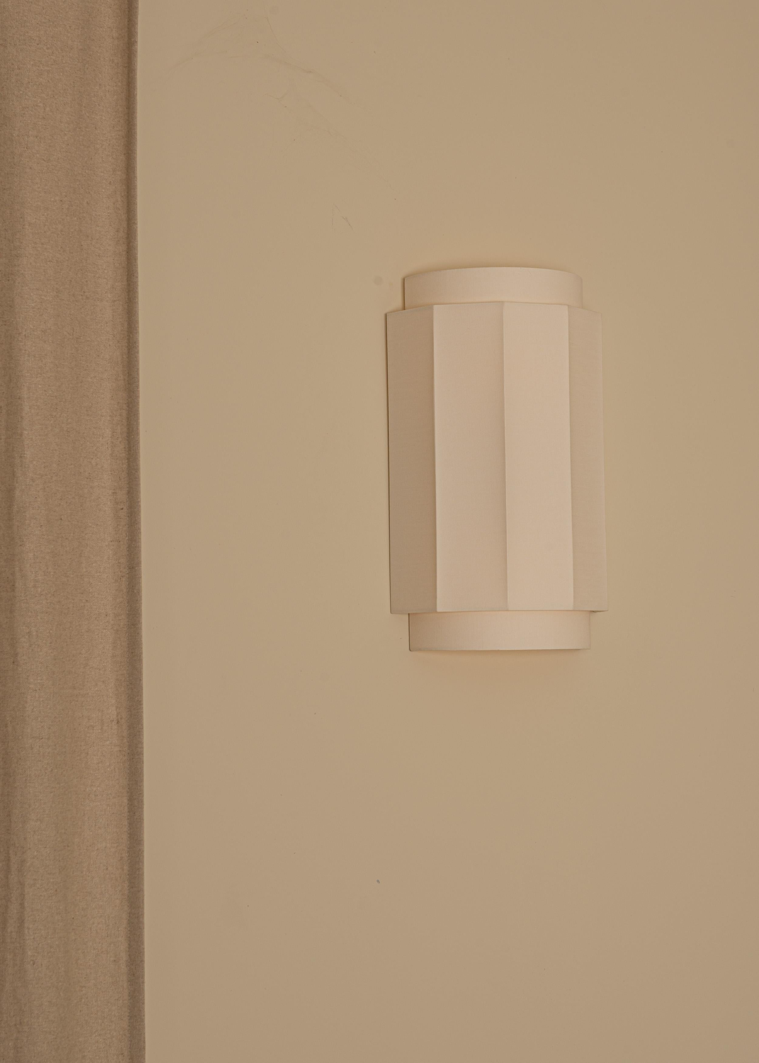 Okla Cotton Wall Sconce by Simone & Marcel
Dimensions: D 12 x W 24 x H 38 cm.
Materials: Cotton.

Custom options available on request. Please contact us. 

All our lamps can be wired according to each country. If sold to the USA it will be wired for