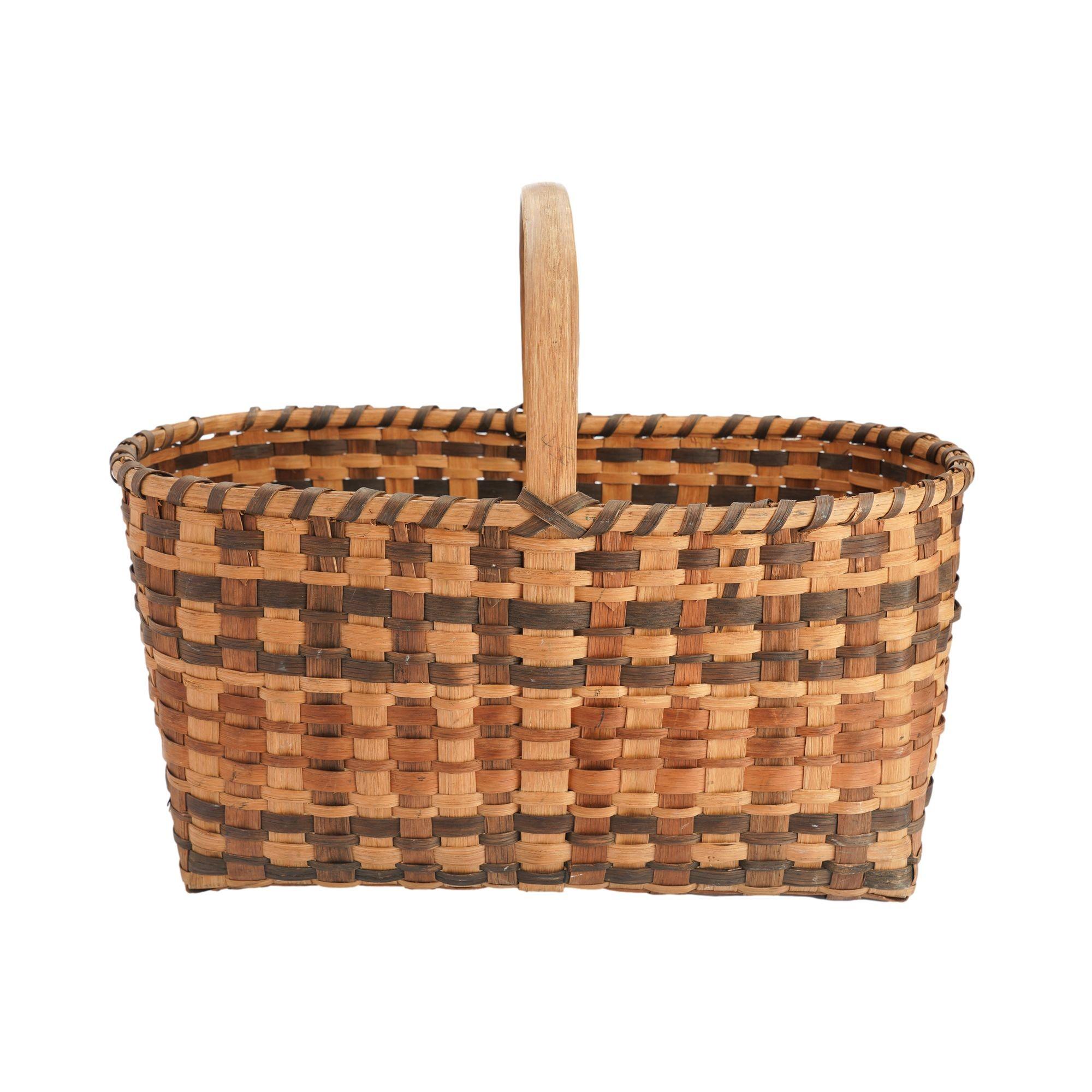 Vintage Oklahoma Cherokee hand woven rectangular basket of split white oak with steam bent white oak handle. Pattern is created with walnut dyed oak splines alternating with un-dyed white oak splines.

Native American, early 20th