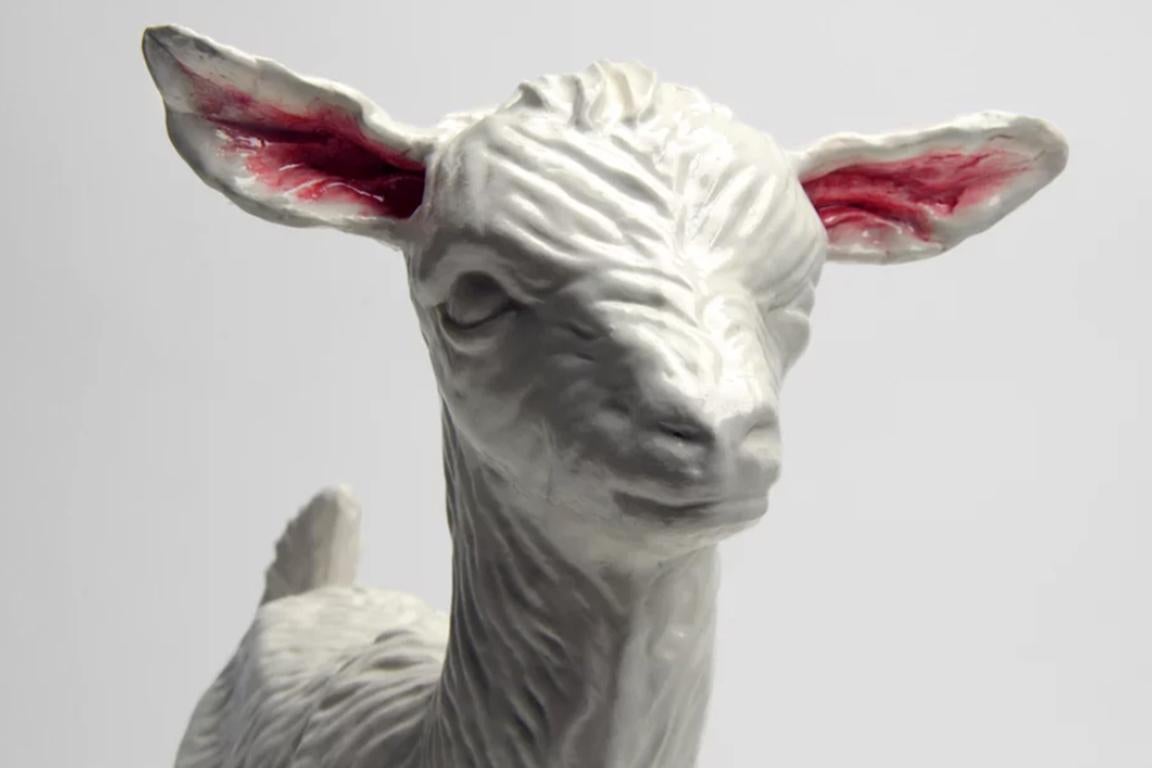 Okuwin is a dreamlike slip-cast porcelain goat sculpture, with a 22k gold luster leg from The Lost Camp's BLACK APOLLO ISLAND SERIES. 

Ethan Kruszka and Mikel Durlam have created the lost camp as a synthesis for their love of design, handmade