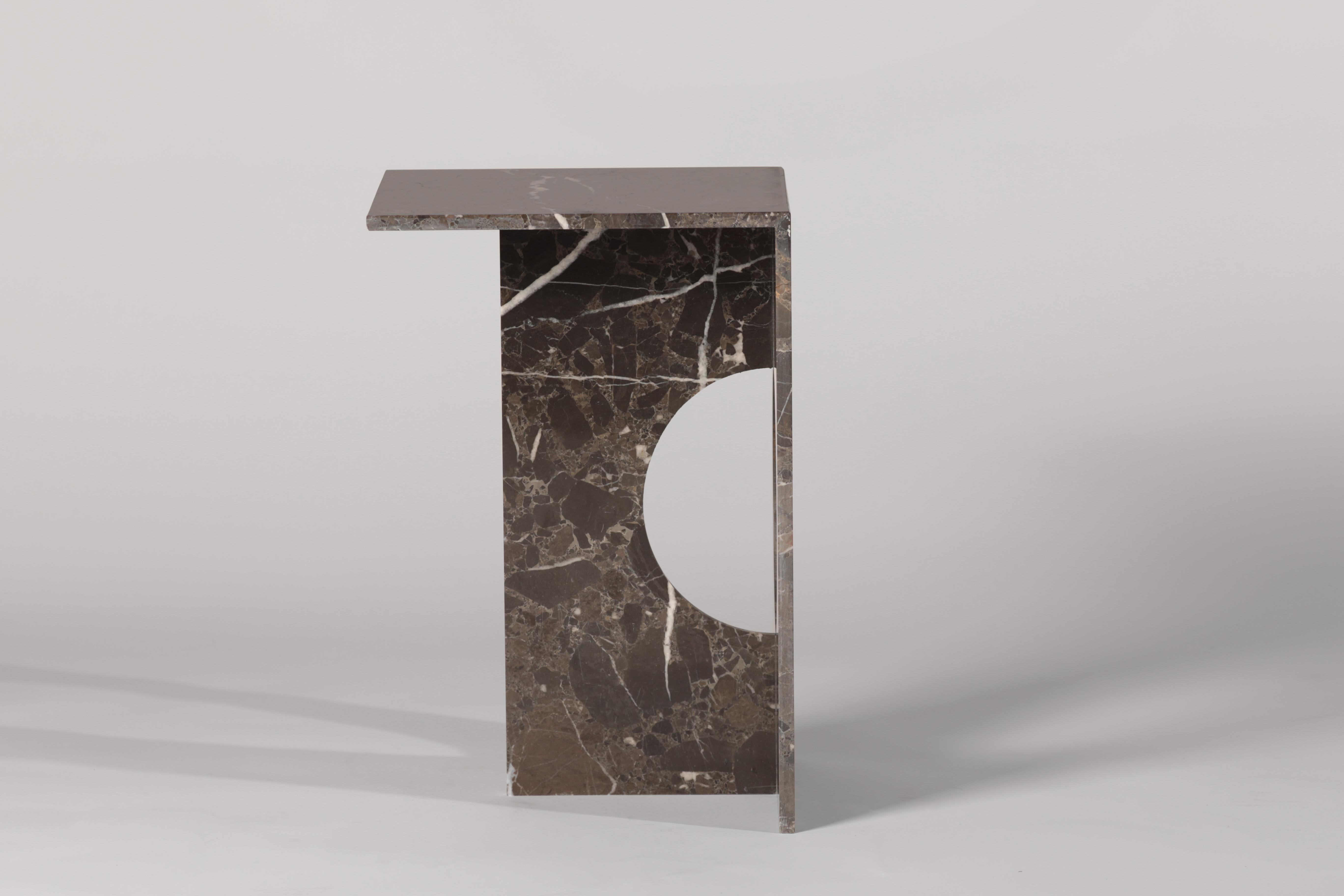 A side table made entirely from marble gives this piece the appearance of a modern sculpture. The Ola side table can be crafted from different types of marble or green diabase volcanic stone if desired. The perfection of machine cutting blends