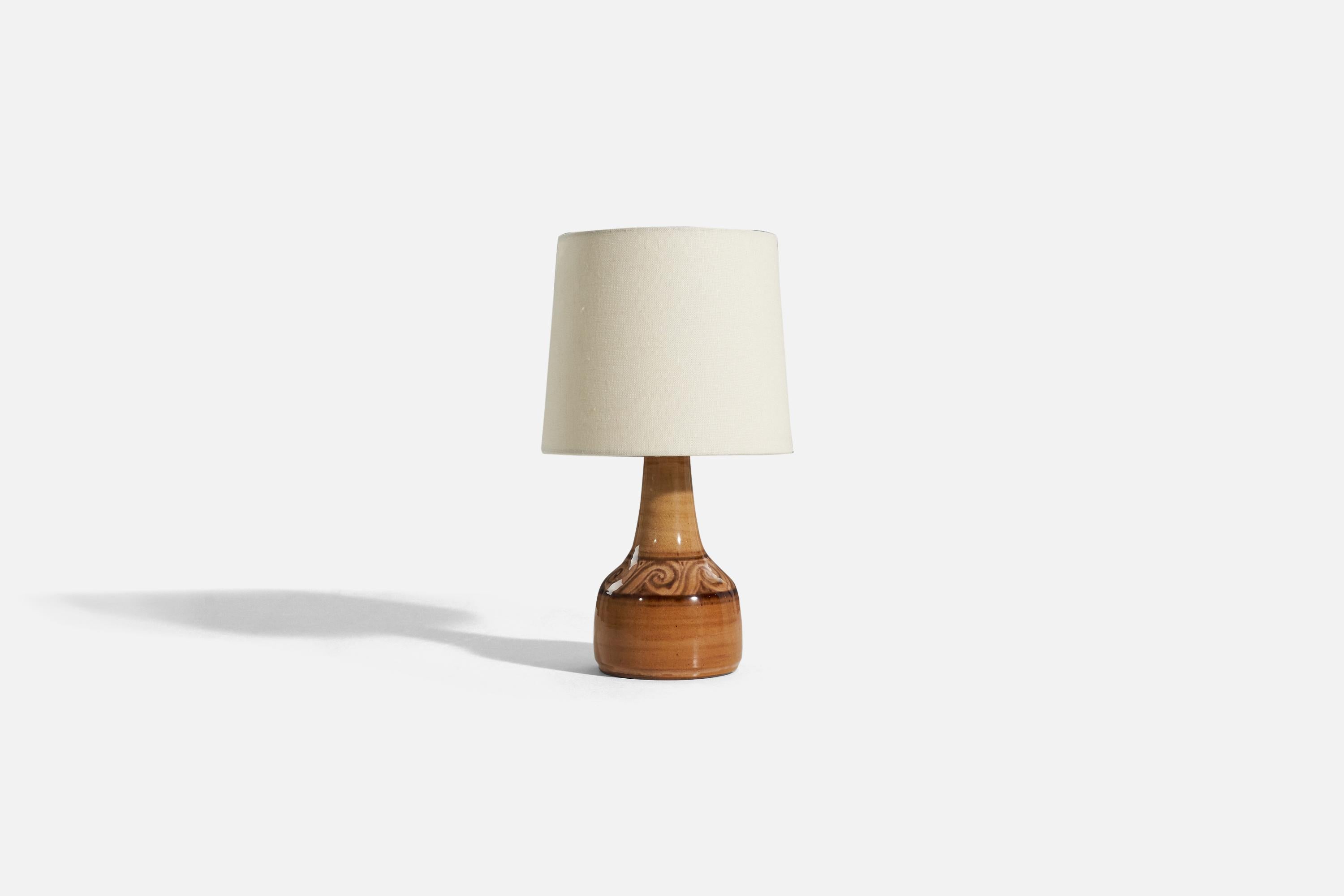 A brown, glazed stoneware table lamp designed and produced by Olav Gyllenborg, Örkelljunga, Sweden, 1975. Signed and dated.

Sold without lampshade. 
Dimensions of lamp (inches) : 10.0625 x 4.75 x 4.75 (H x W x D)
Dimensions of shade (inches) :