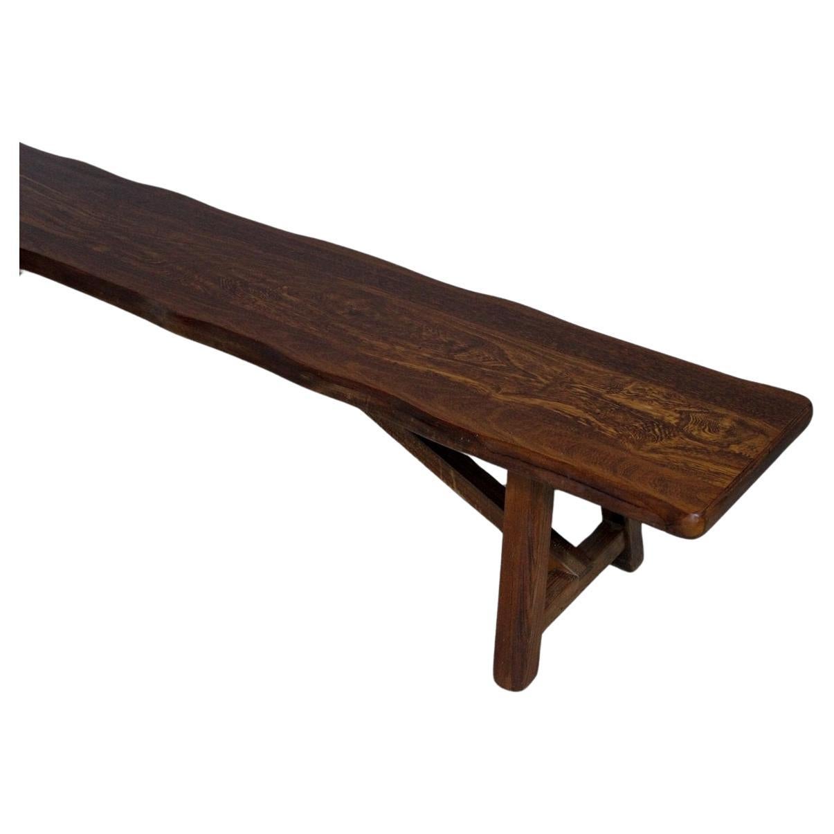 A unique and minimalist elm wood bench by Olavi Hanninen, circa 1950s. Amazing bench Brutalist design with thick wood seat, beautiful slightly wavy wood beam back and chunky angled legs. Original wood finish showing nice age and patina. 

The 1950s