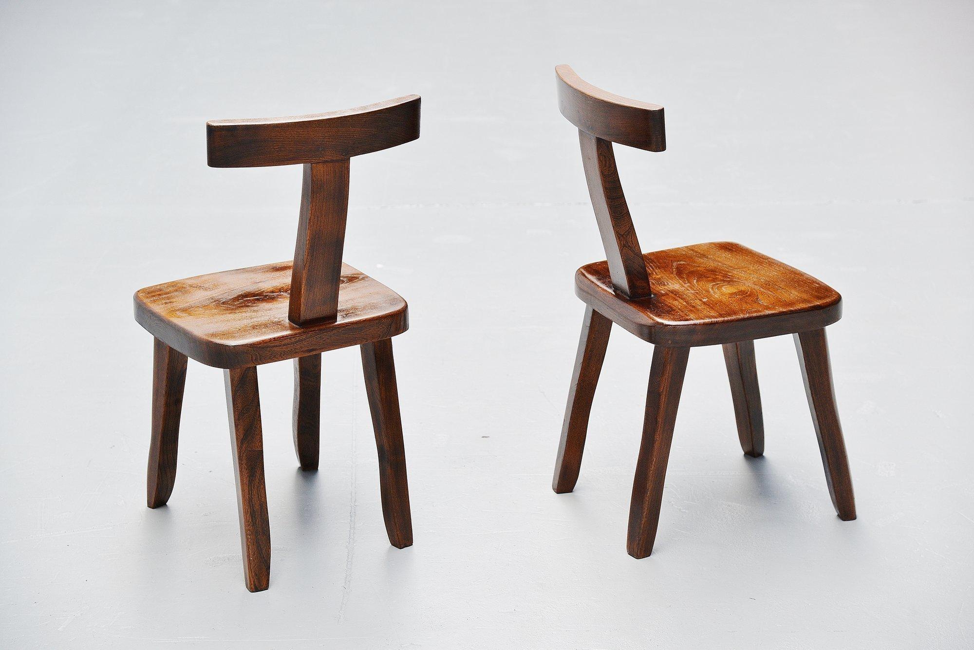 Very nice sculptural side chairs designed by Olavi Hanninen and manufactured by Mikko Nupponen, Finland, 1950. These chairs are made of stained elm wood, sculpturally crafted, handmade chairs with nice brass detailed nails. Very nicely shaped and in