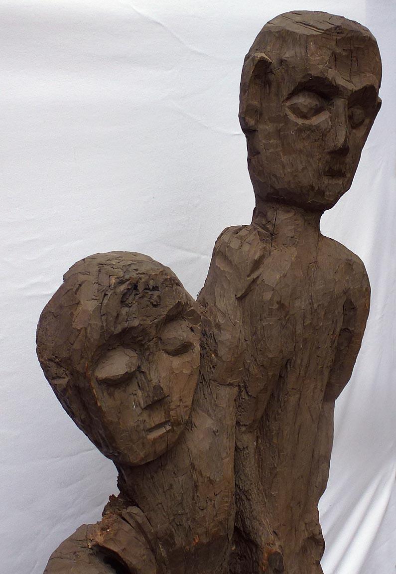 Hand-Carved Old 4 foot high naive and stylized carving of two people from 1 slab of wood For Sale