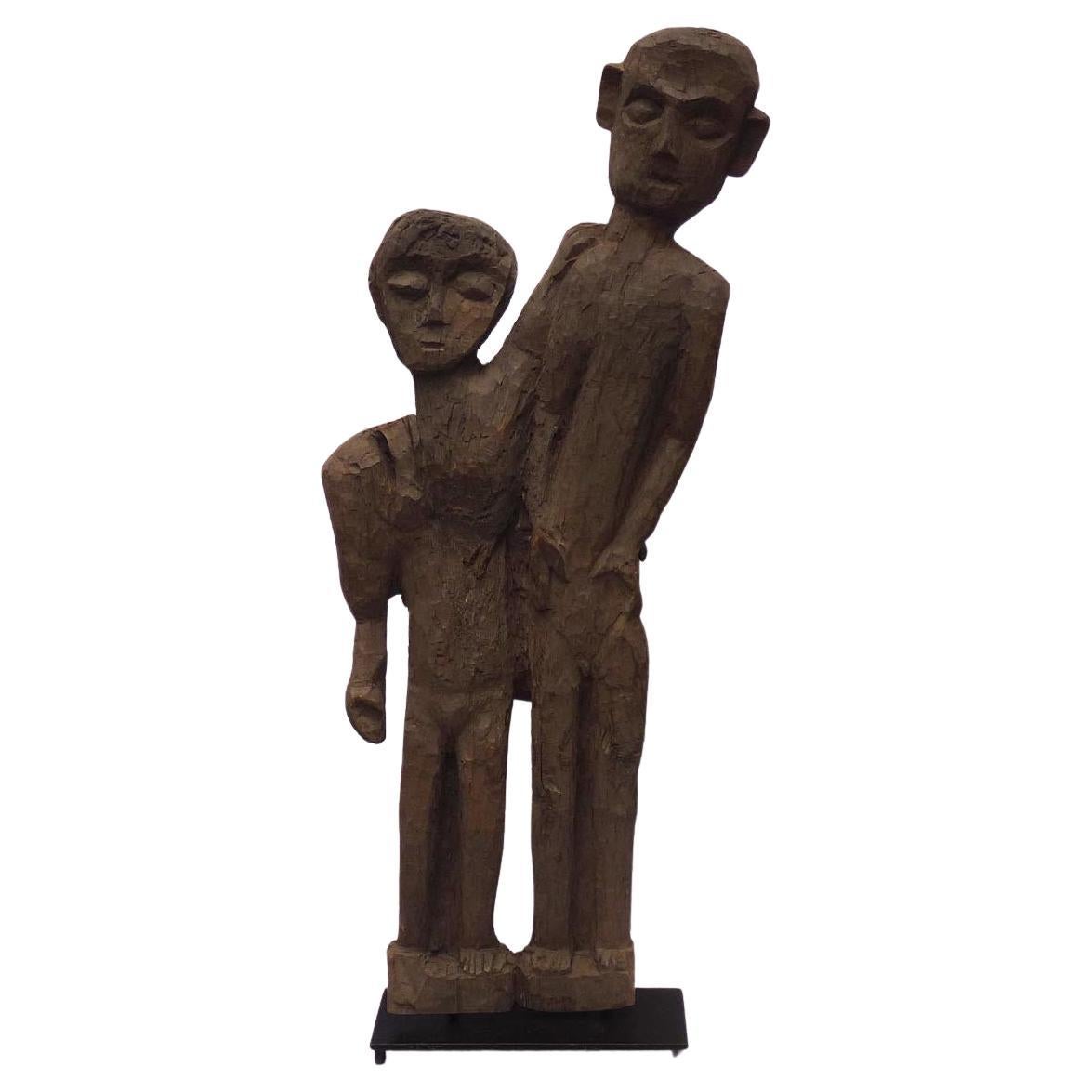 Old 4 foot high naive and stylized carving of two people from 1 slab of wood For Sale