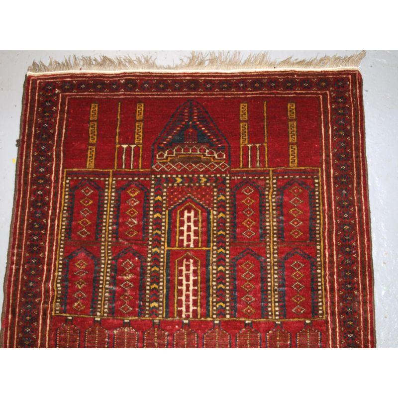 Old Afghan prayer rug of traditional village mosque design, probably Kizil Ayak Turkmen.

The rug is of typical mosque design showing a mosque at the top and the field depicting the inside of a mosque.

The rug is in good condition with slight