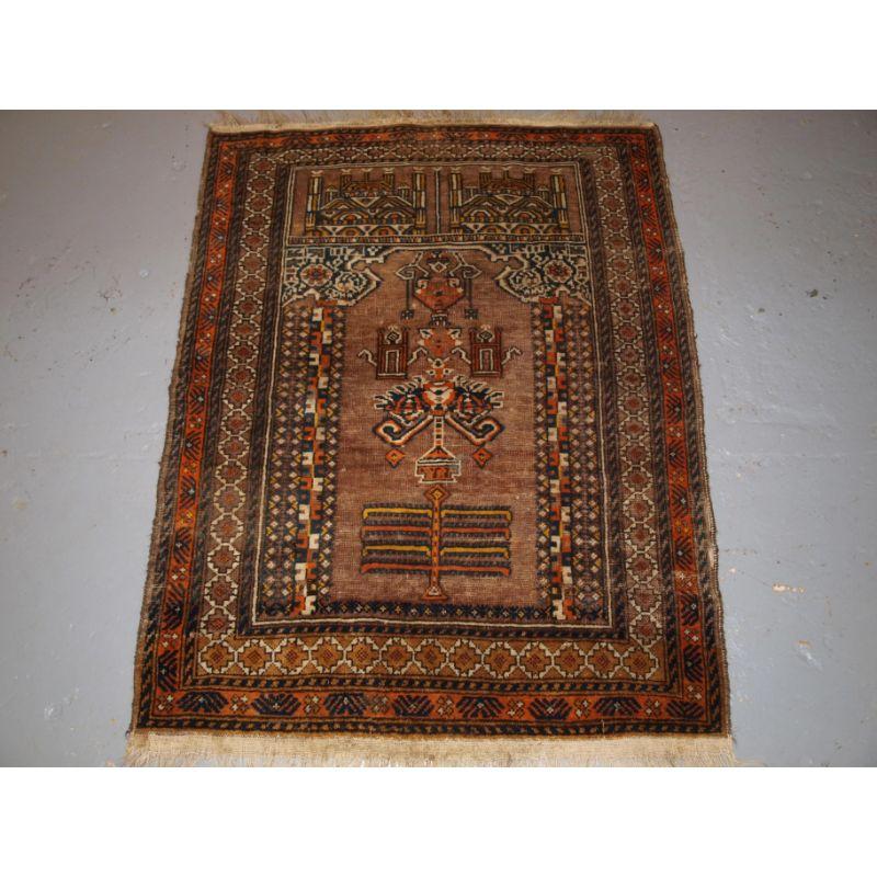 Old Afghan prayer rug of traditional village mosque design, probably Kizil Ayak Turkmen.

The rug is of typical mosque design showing two mosques at the top and the field depicting the inside of a mosque.

The rug is in fair condition with some