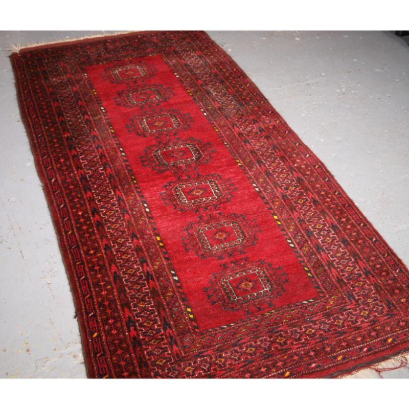 Old Afghan village rug with a single row of seven large Turkmen turreted guls.

Circa 1920

The rug is of a typical design from a Northern Afghan village, the colour is bright and clear with excellent wool.

The rug is in good condition with slight
