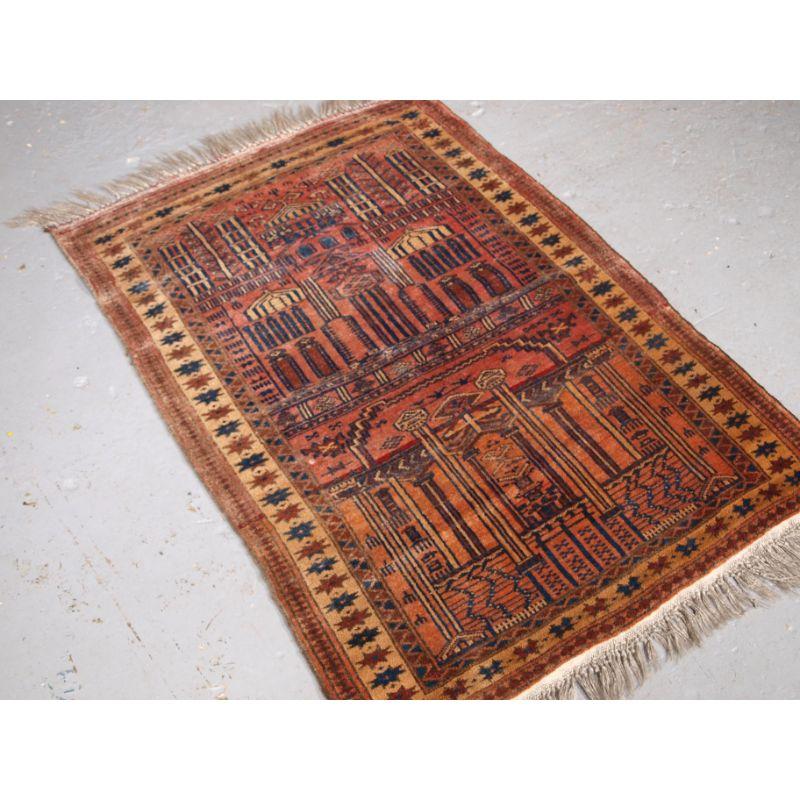 Old Afghan prayer rug of traditional village mosque design, probably Kizil Ayak Turkmen.

The rug is of interesting mosque design showing both internal and external views of a mosque. This is a rug woven with very soft wool and a subtle colour