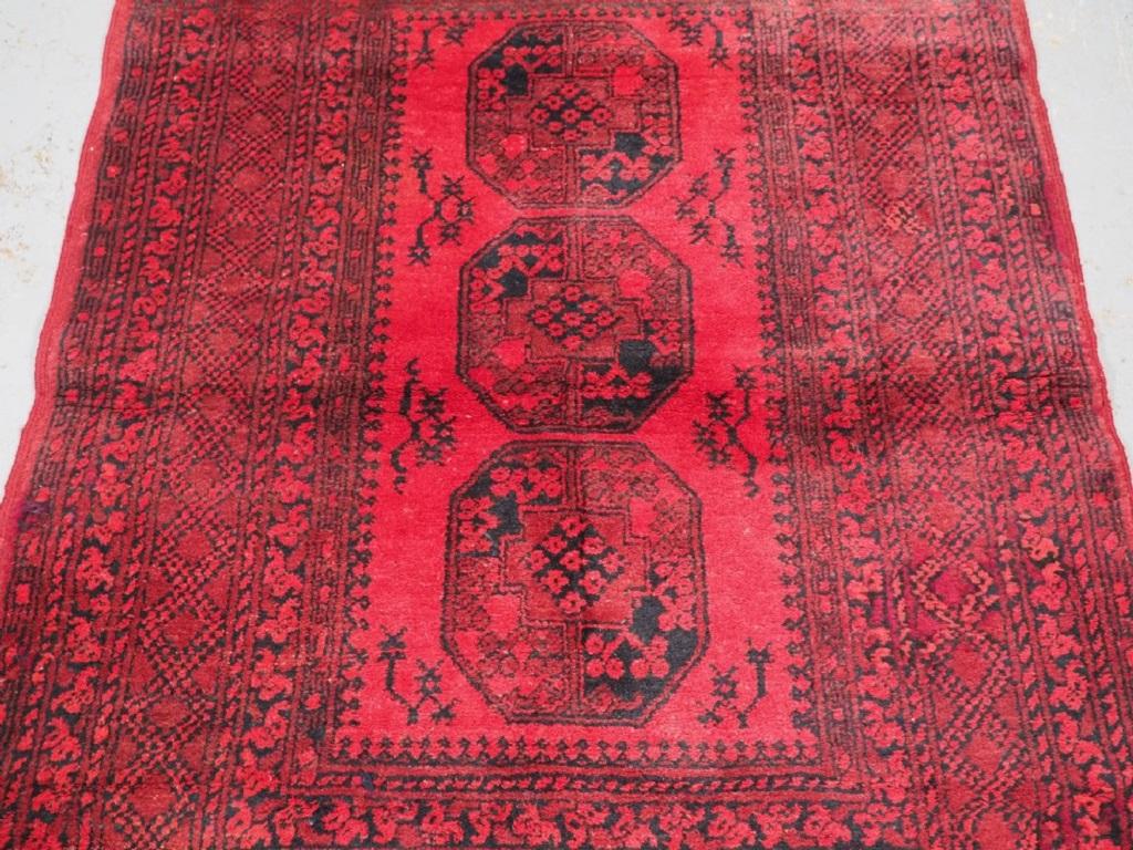 Old Afghan village rug of traditional design with large guls, the rug is of a warm red colour with dark indigo blue The rug has very glossy wool as can be seen in the images
Circa 1940

The rug is in excellent condition with very slight even wear
