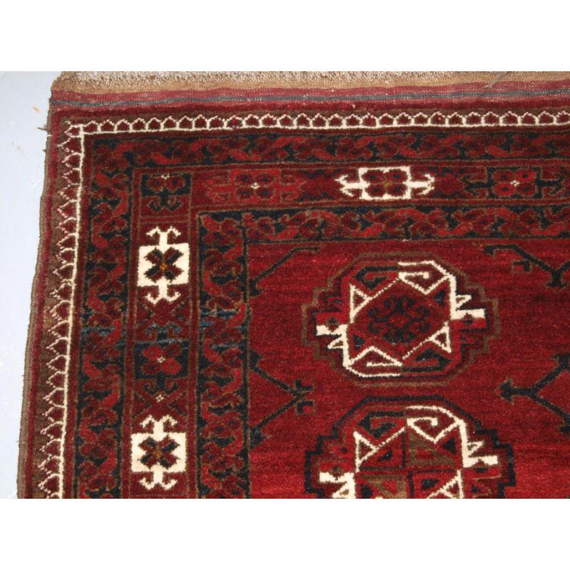 Old Afghan village rug of traditional Ersari Kizil Ayak design with two rows of eight large guls, the rug is of a pleasing deep red colour with dark indigo blue and ivory. The wool has a wonderful lustre and is very soft.

The rug is in excellent