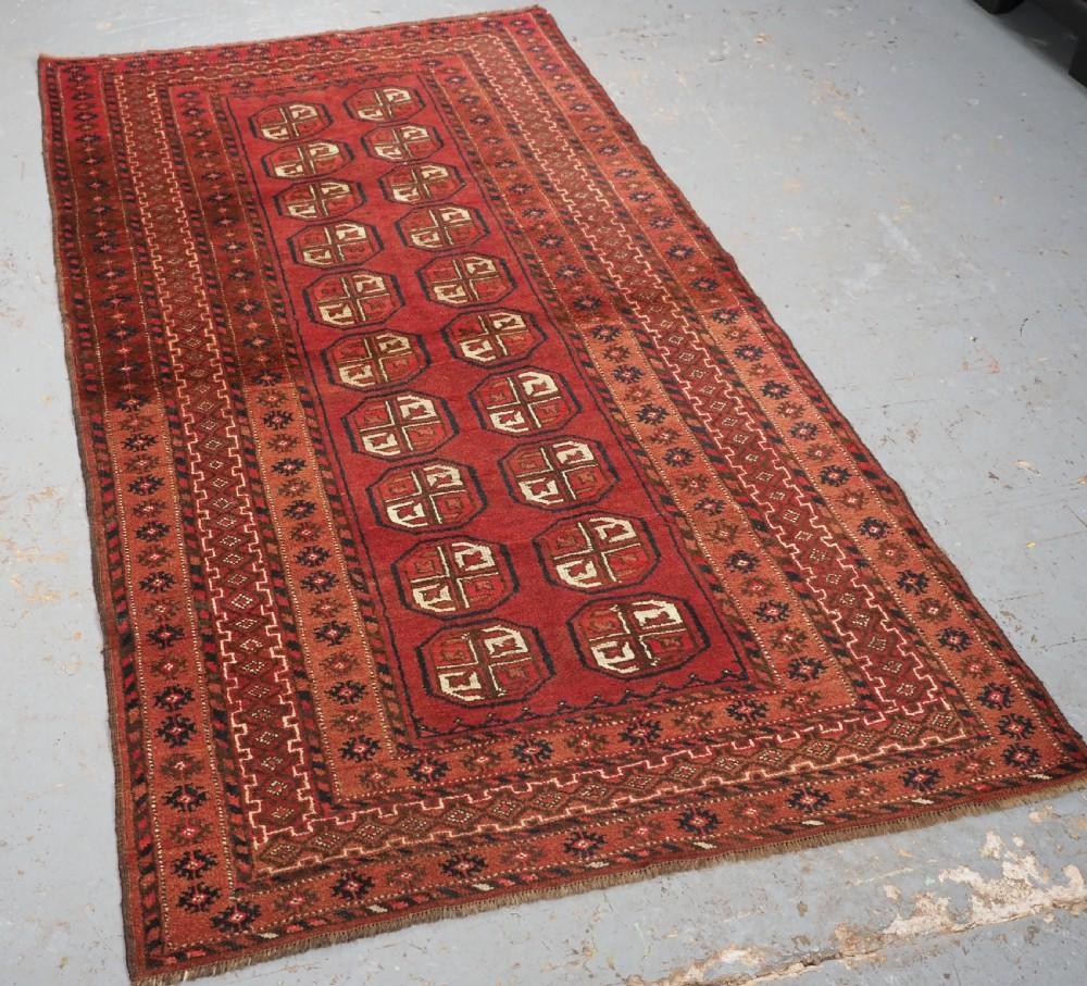 Old Afghan village rug of traditional Turkmen design, the rug is a warm shaded red colour
Circa 1920

The rug has two rows of traditional Turkmen guls, as can be seen in the images the shade of red changes half way up the rug, this is not fading; it