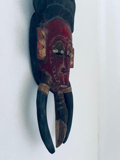 Old African mask in noble hand carved and painted wood circa 1900.