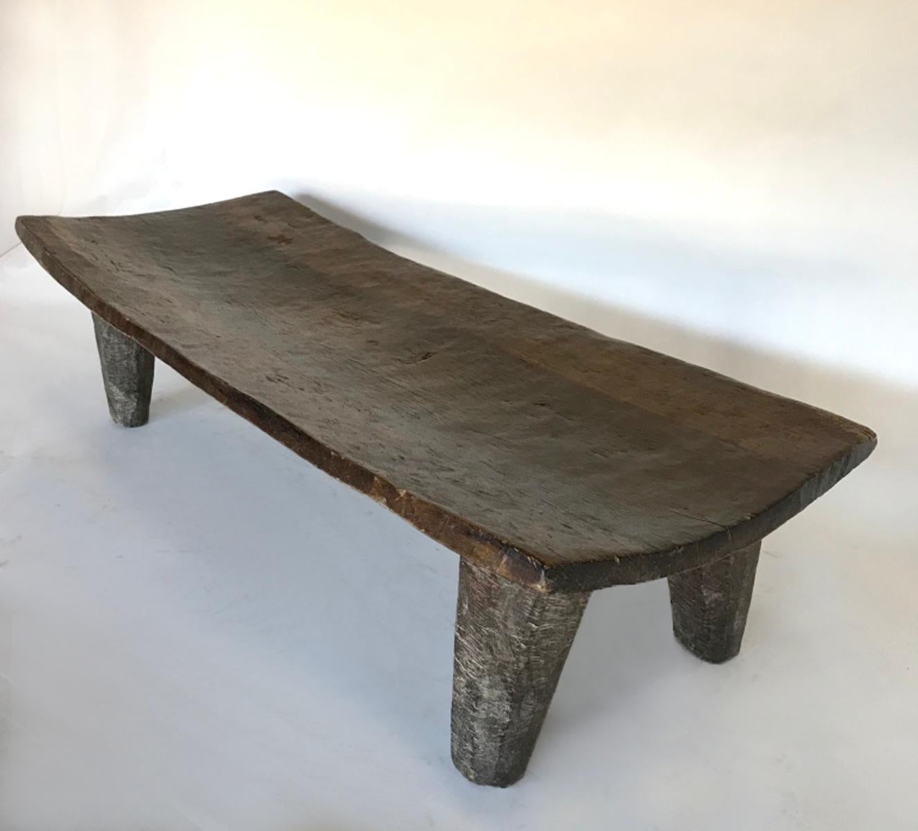 Carved out of one single piece of wood, this bed is from the Nupe tribe in northern Nigeria. Wonderful old patina throughout. Carved conical primitive legs. Great little coffee table, bench or low console under a piece of art.