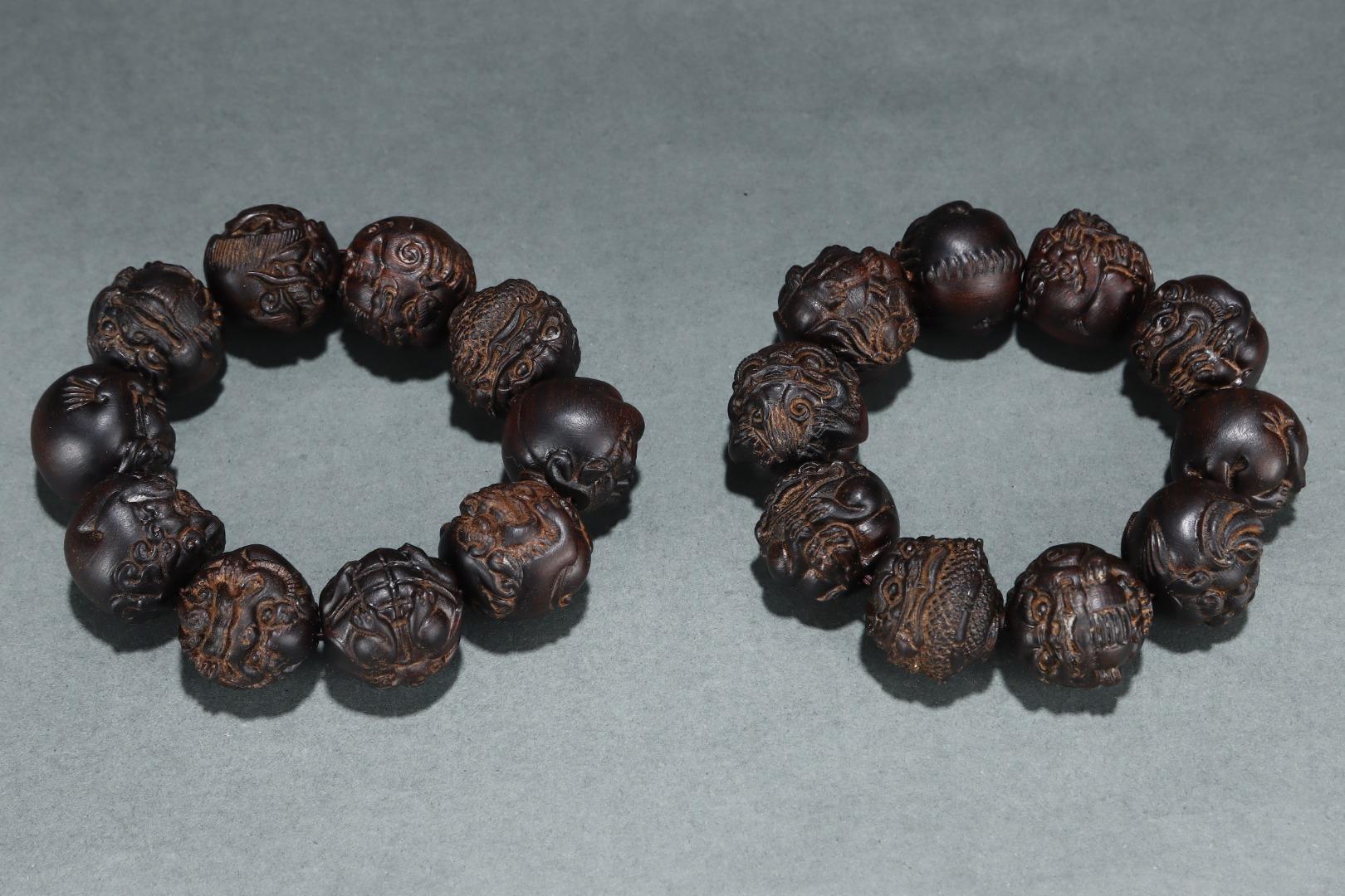 This Old Agarwood Carving Golden Toad Beads Bracelets Pair is an exquisite and spiritually significant set, skillfully crafted from rare agarwood—a material celebrated for its natural fragrance and meditative properties. The bracelets feature