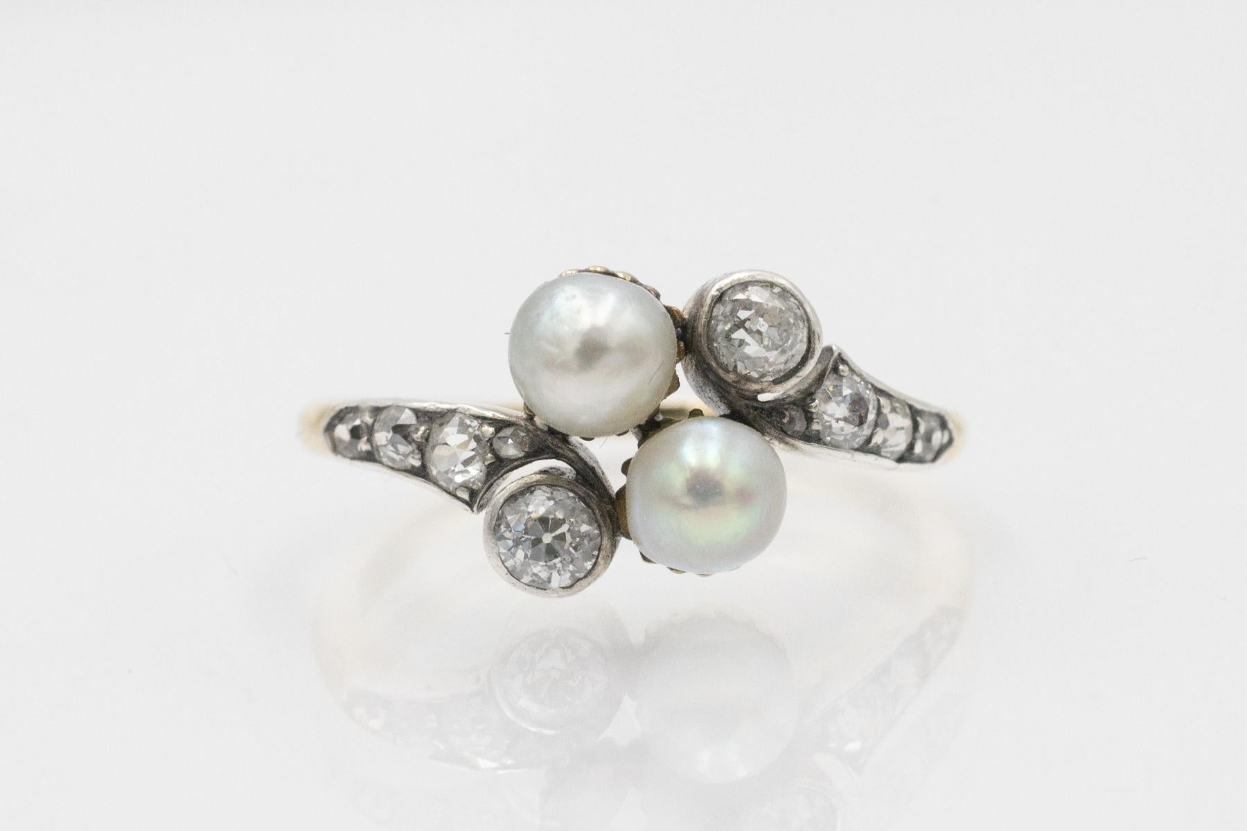 This gold ring set with old-cut diamonds and two pearls is a classic piece of early 20th-century jewelry.

This striking pearl and diamond arrangement is typical of the Art Nouveau style.

Origin: Western Europe, likely France, early 20th
