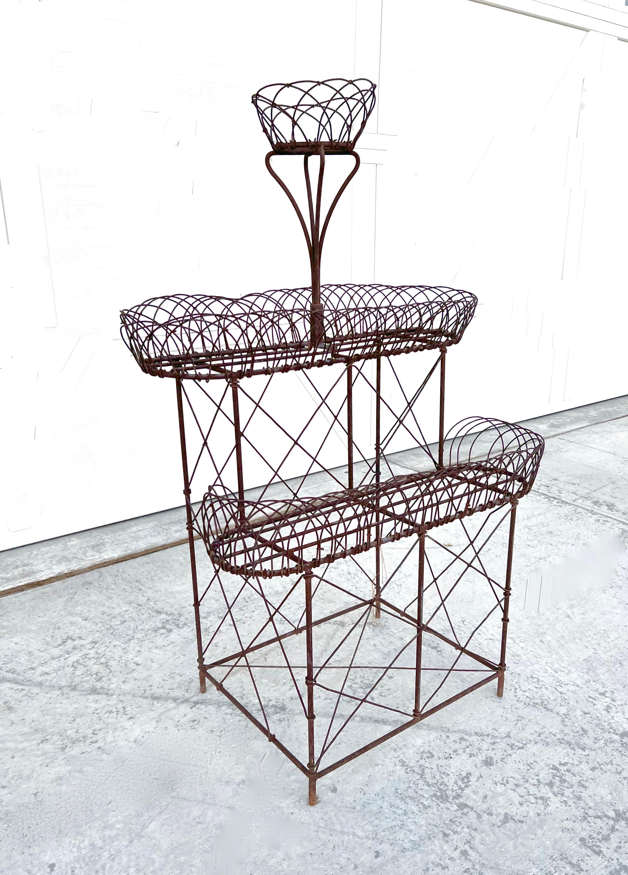 Old French Art Nouveau Style Three Tier Iron Wire Metal Planter Plant Stand

Fabulous vintage wrought iron three-tier plant stand! Beautiful Victorian style with lovely, rusted patina to the ironwork. It is in beautiful condition with