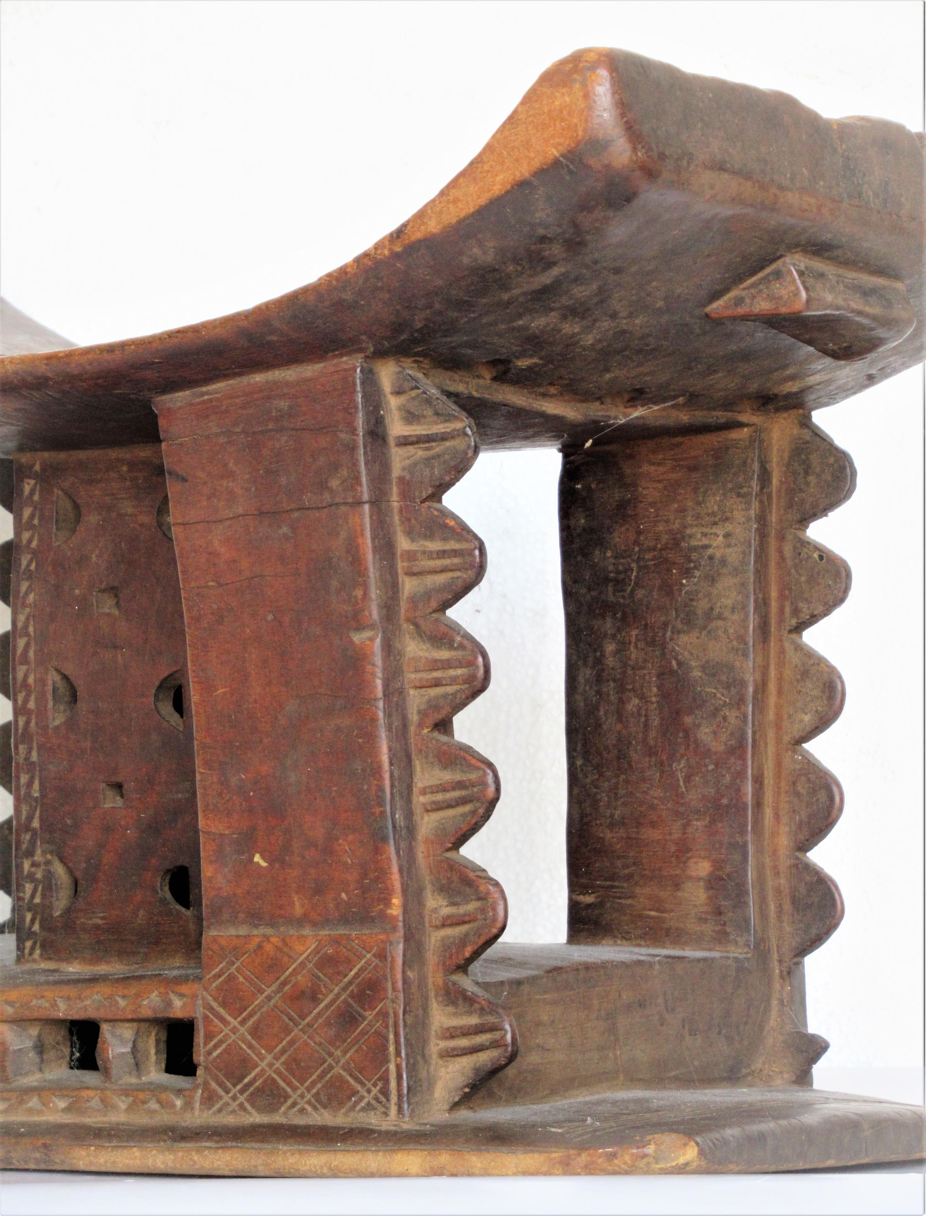 Classic Ashanti ( Asante ) stool from Ghana. Finely carved from a single piece of wood in beautifully aged old surface color. Early 20th century.
. Great looking and genuinely old. Look at all pictures and read condition report in comment section.