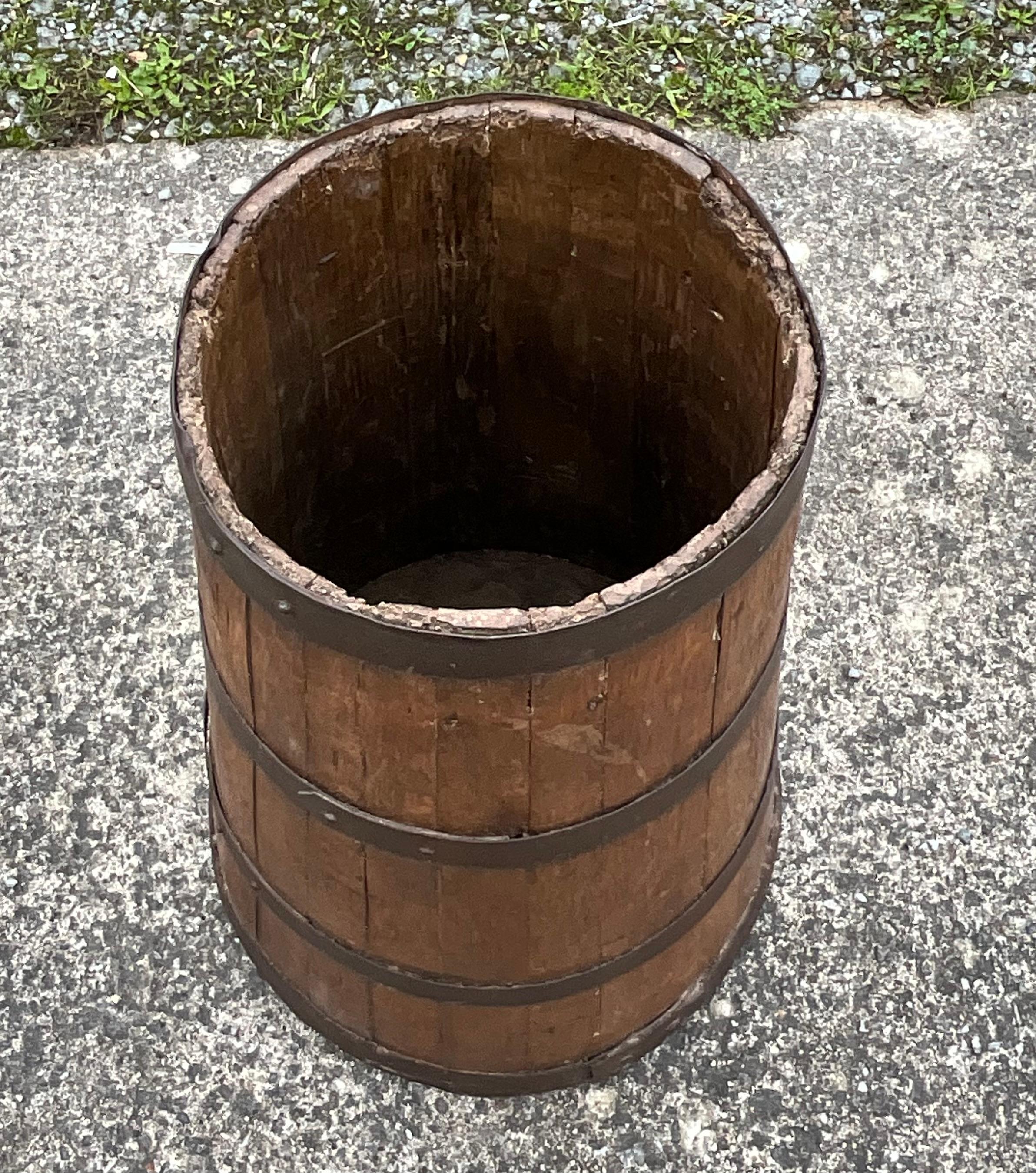 Old barrel of French manufacture

This cylindrical container is made of solid oak. 

This barrel has aged and blackened over time to the point of giving it a greyish color. This phenomenon is due to the oxidation of tannins.

The cooper used this