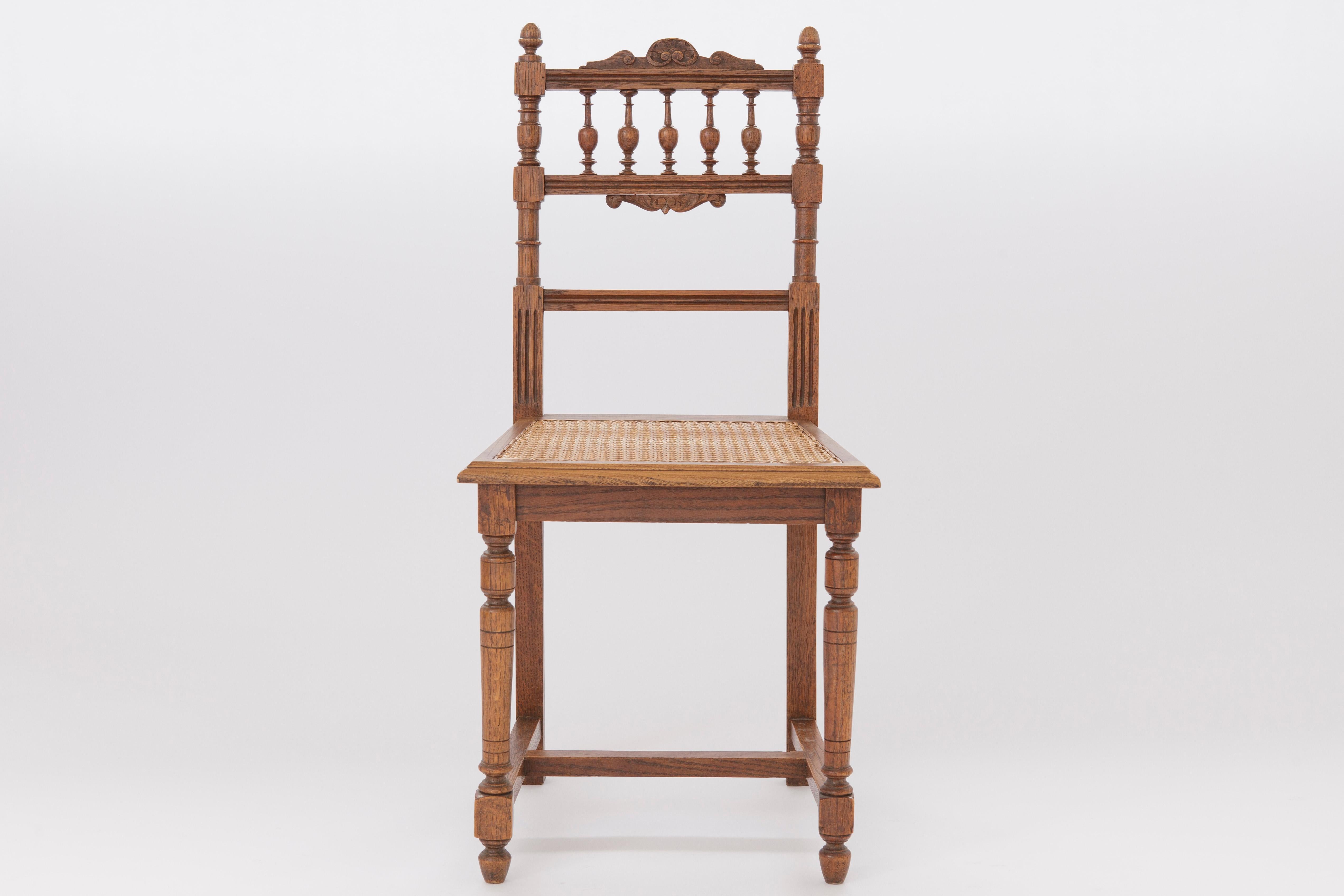 Antique desk or dining chair. 
Production period: approx. First half of the 20th century
Origin: Belgium 

Very good and stable condition of the wood frame.  
The weaving seems to be still original and not very strong to use the chair regular. 
The