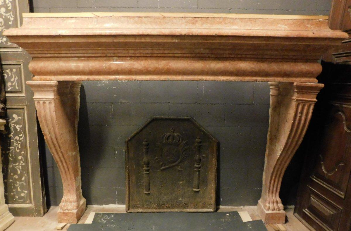 Old fireplace, mantle carved in solid red Verona marble, carved with wavy legs and column groove, and lion's paw on the foot, built in the early 1900s for a palace in northern Italy (freely inspired by ancient fireplaces of the Italian Renaissance,