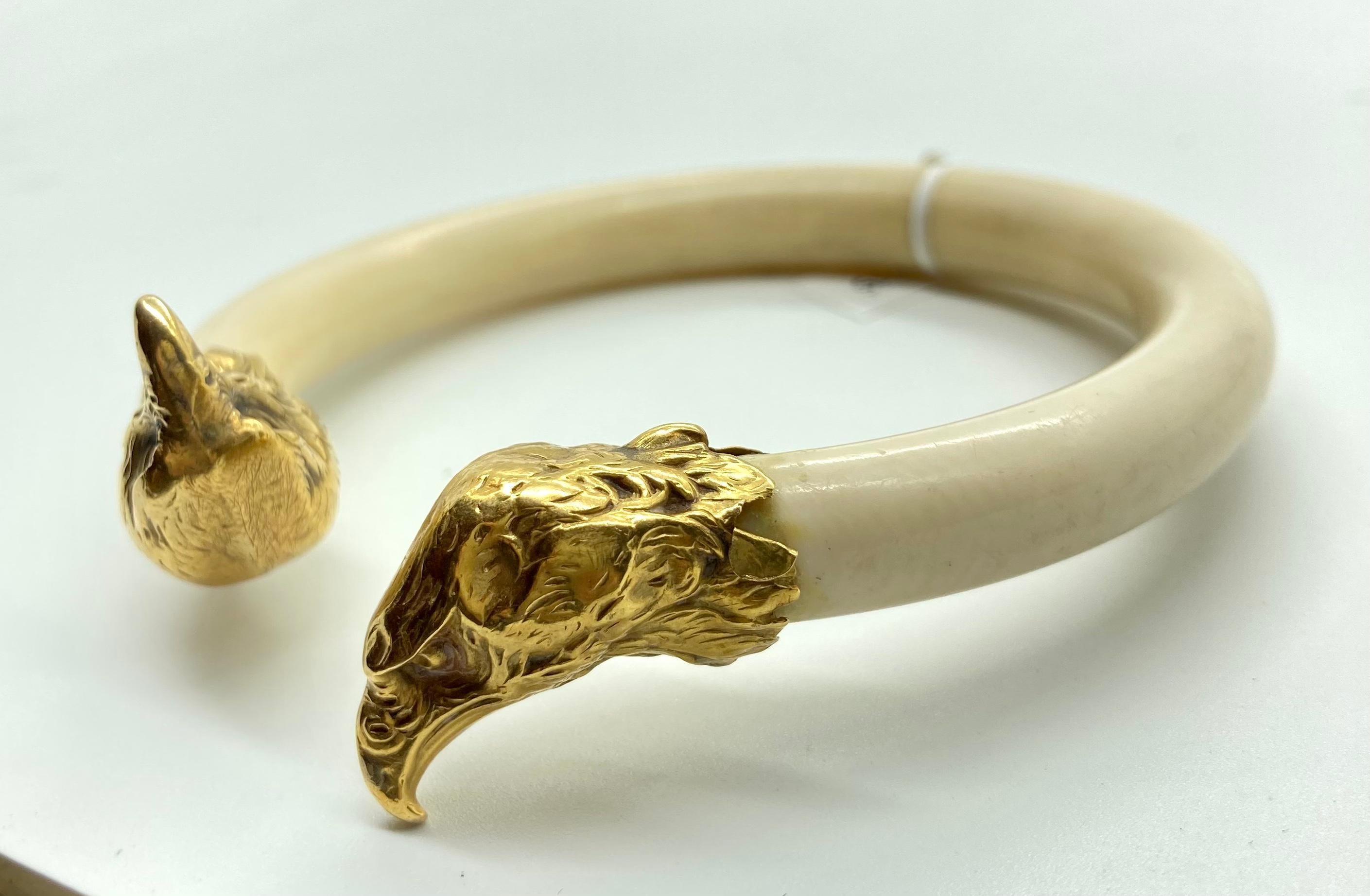 A chic old bone and 18 karat yellow gold eagle bangle bracelet. Made in France, circa 1950.