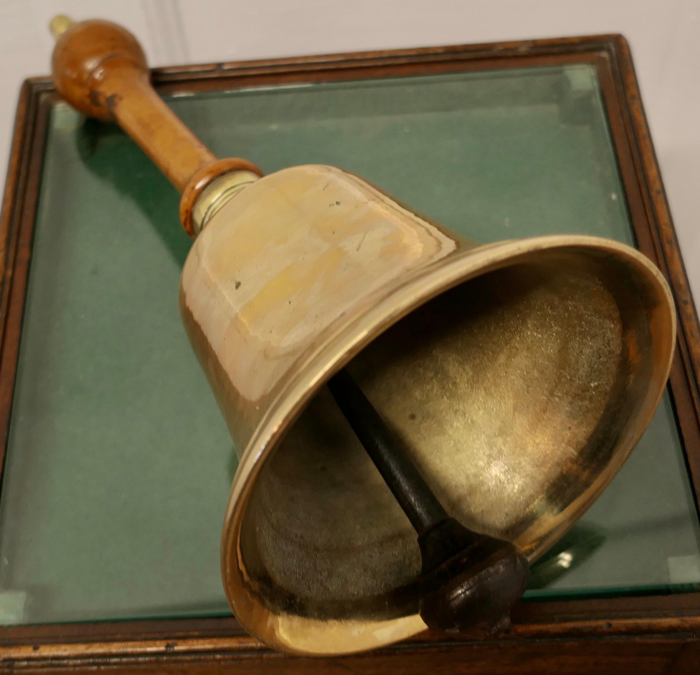 Old brass hand bell, town Cryer’s or School Bell.

A Great piece larger and heavier than most, the bell is made in solid brass and has a beautiful sycamore turned handle with a brass acorn on the top
The bell is 14” high, and 7” in