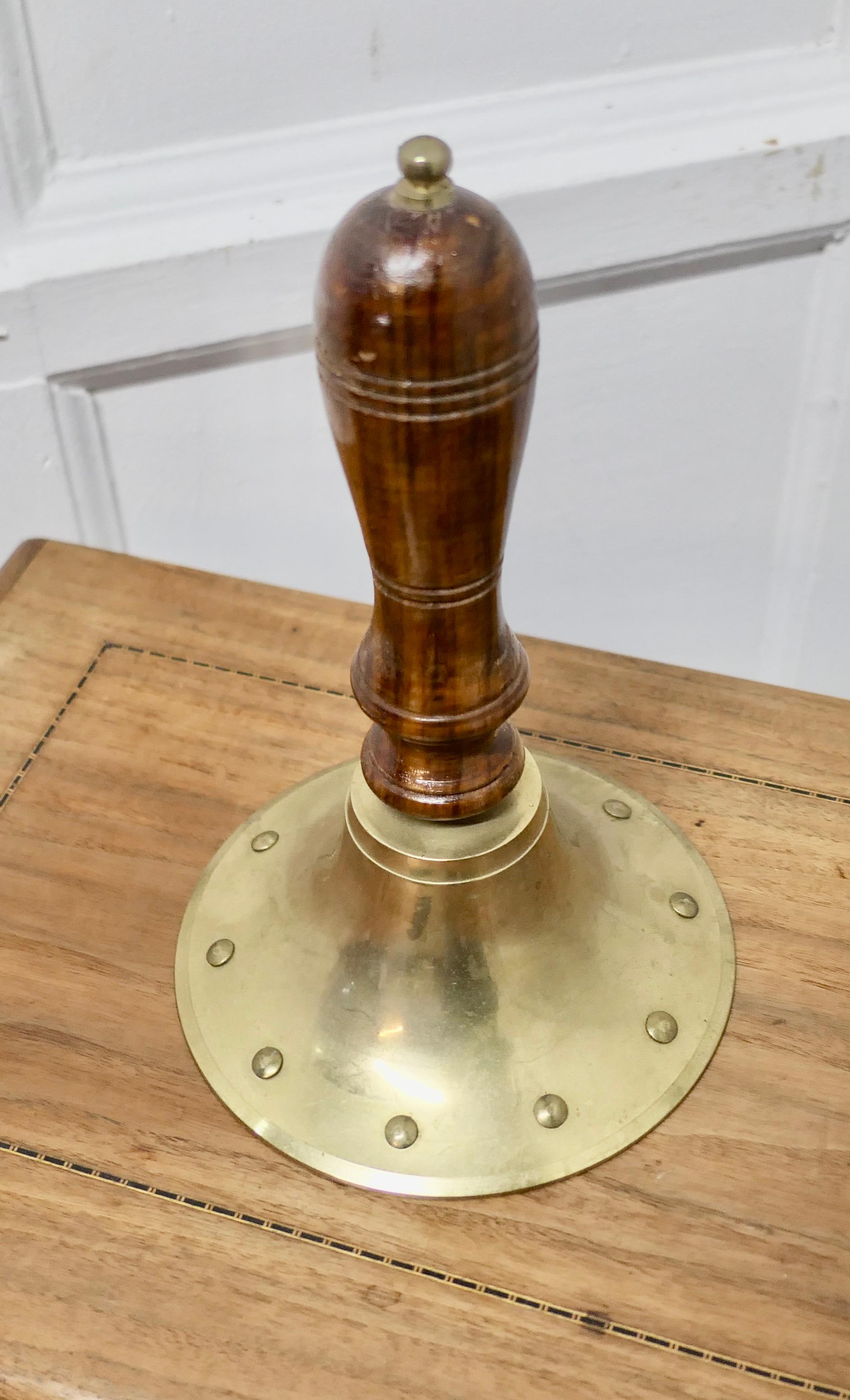 Old Brass Ships Dinner Hand Bell 

A Great piece,  the bell is made in solid brass with the unusual addition of a riveted decoration and it has a beautiful teak turned handle 
The bell is 12” high, and 7” in diameter
TSC30
