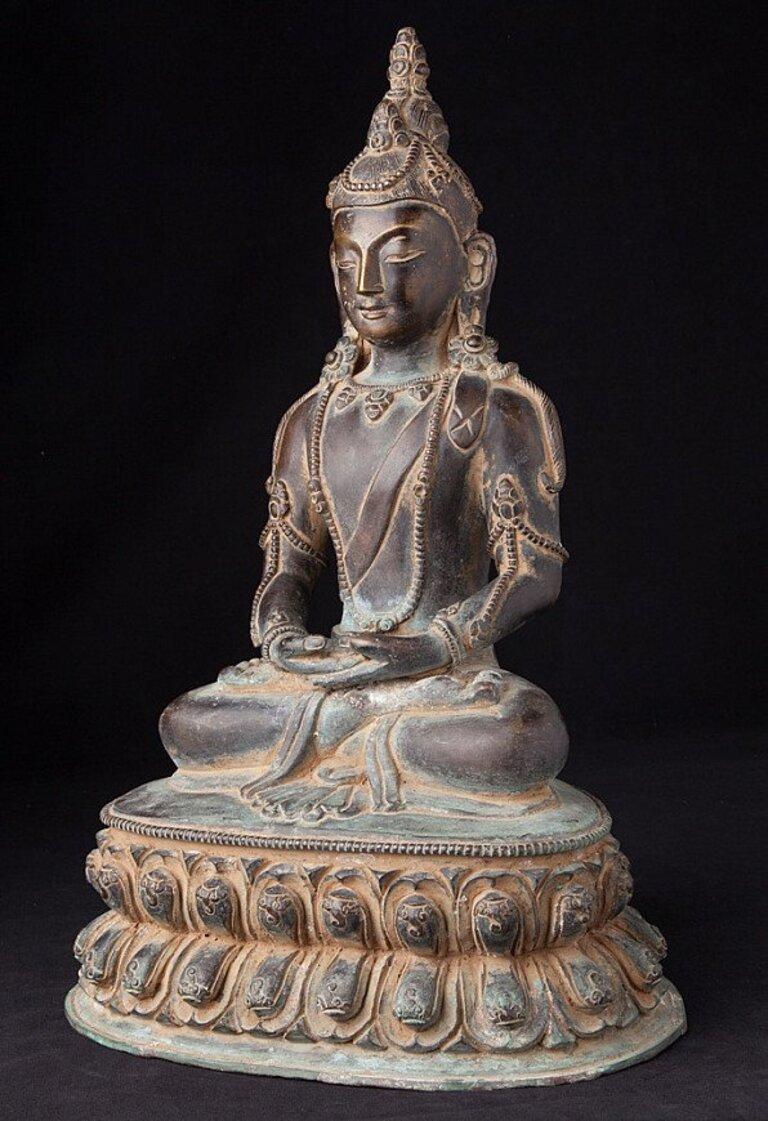 This antique bronze Buddha statue is a truly unique and special collectible piece. Standing at 40 cm high, 26 cm wide and 19 cm deep, it is made of bronze and it depicts the Dhyana mudra. This statue is believed to originate from Nepal and dates