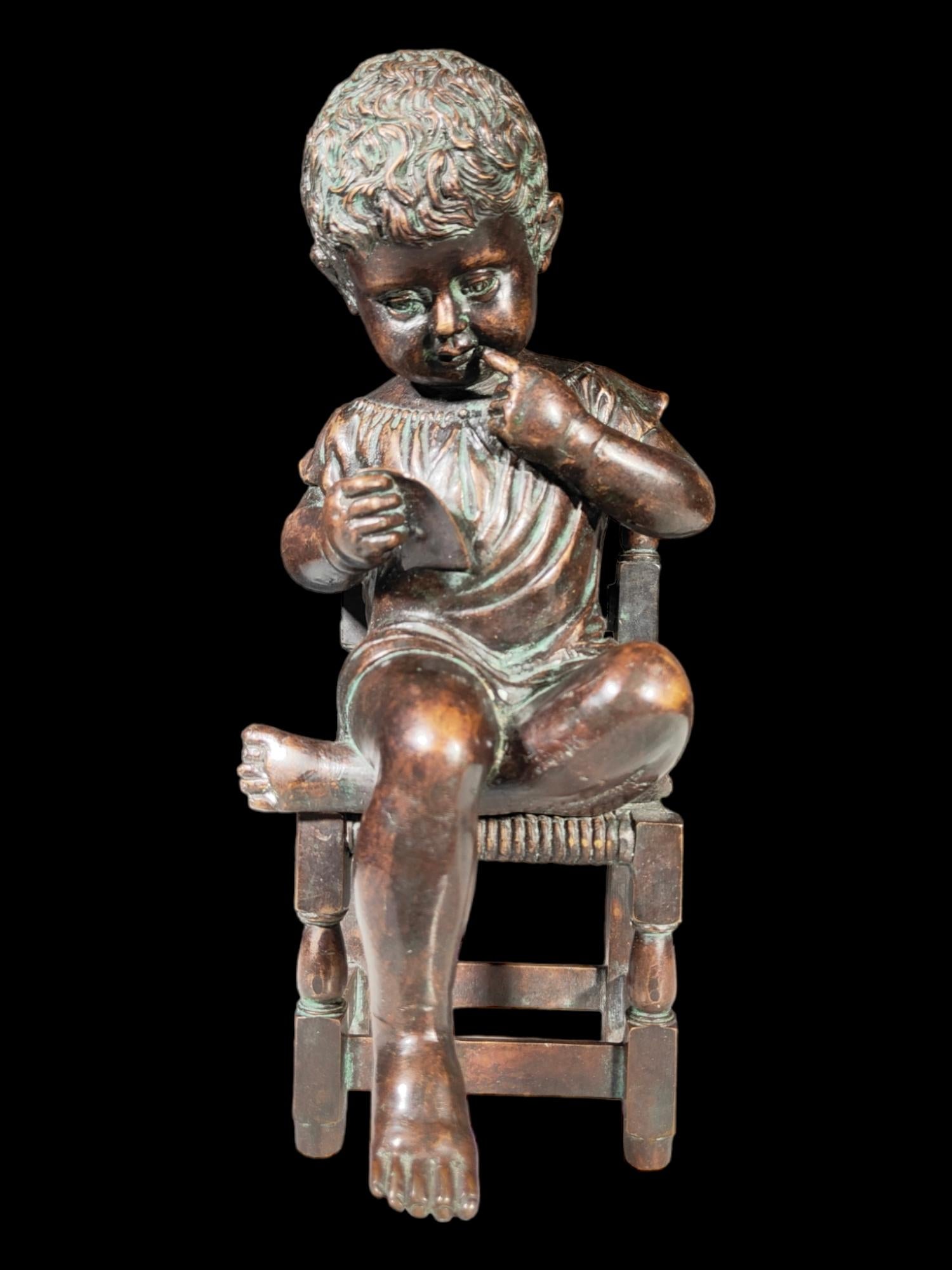 Antique bronze from the 19th century representing a child sitting on a chair. Measures: 32x17x13 cm.