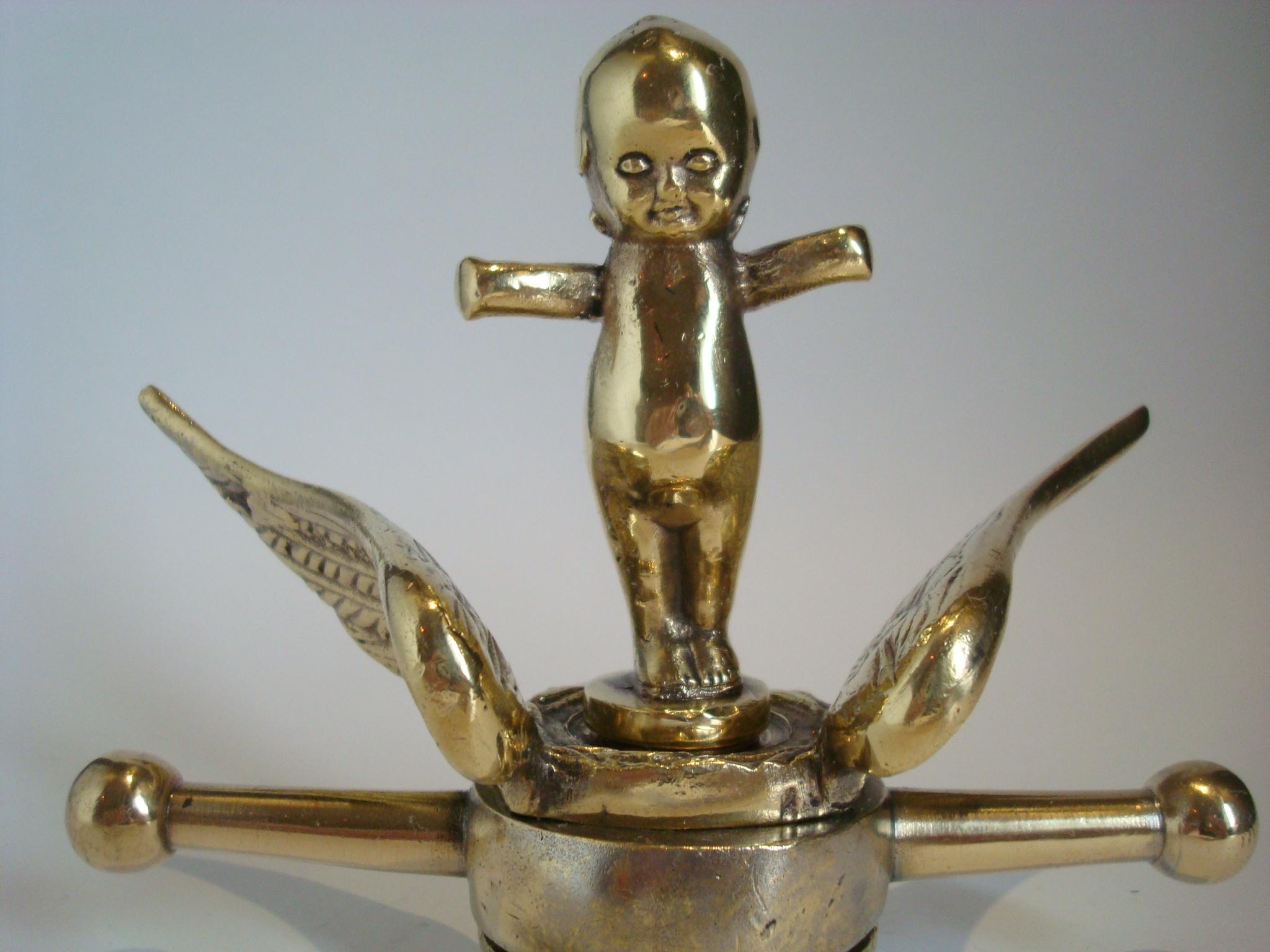 Old bronze kewpie doll car Mascot / hood ornament. 1912-1920´s.
Mounted over a wings radiator cap. Perfect gift for any Car Fan / Automobilia. Can be used as a paperweight.
Kewpie is a brand of dolls and figurines that were conceived as comic