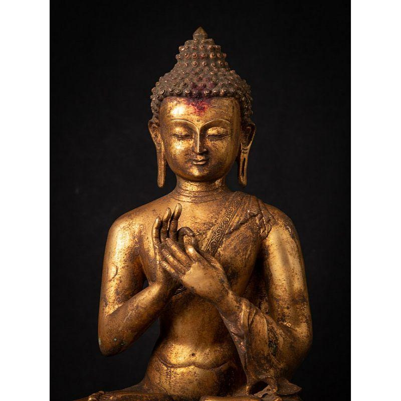 Material: bronze.
Measures: 43, 7 cm high. 
35, 5 cm wide and 25, 1 cm deep.
Weight: 8.35 kgs.
Fire gilded with 24 krt. gold.
Dharmachakra mudra.
Originating from Nepal.
Early 20th century.
Very high quality !
 