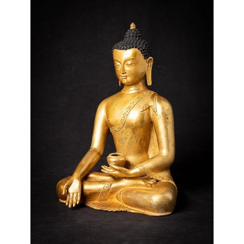 Material: bronze
Measures: 31,8 cm high 
23 cm wide and 17,6 cm deep
Weight: 4.482 kgs
Fire gilded with 24 krt. gold
Varada mudra
Originating from Nepal
Middle 20th century
Very high quality !

