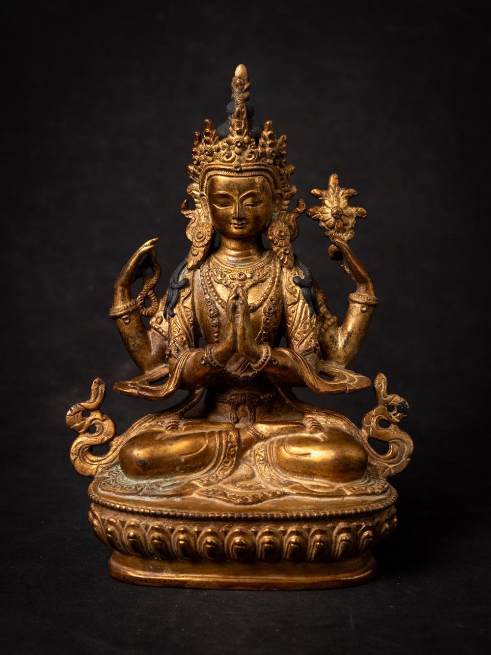 This old bronze Chenrezig statue from Nepal is a remarkable piece of religious artistry. Crafted from bronze and adorned with intricate fire gilding, it stands at a height of 22.1 cm, with dimensions of 16 cm in width and 8.5 cm in depth. Chenrezig,