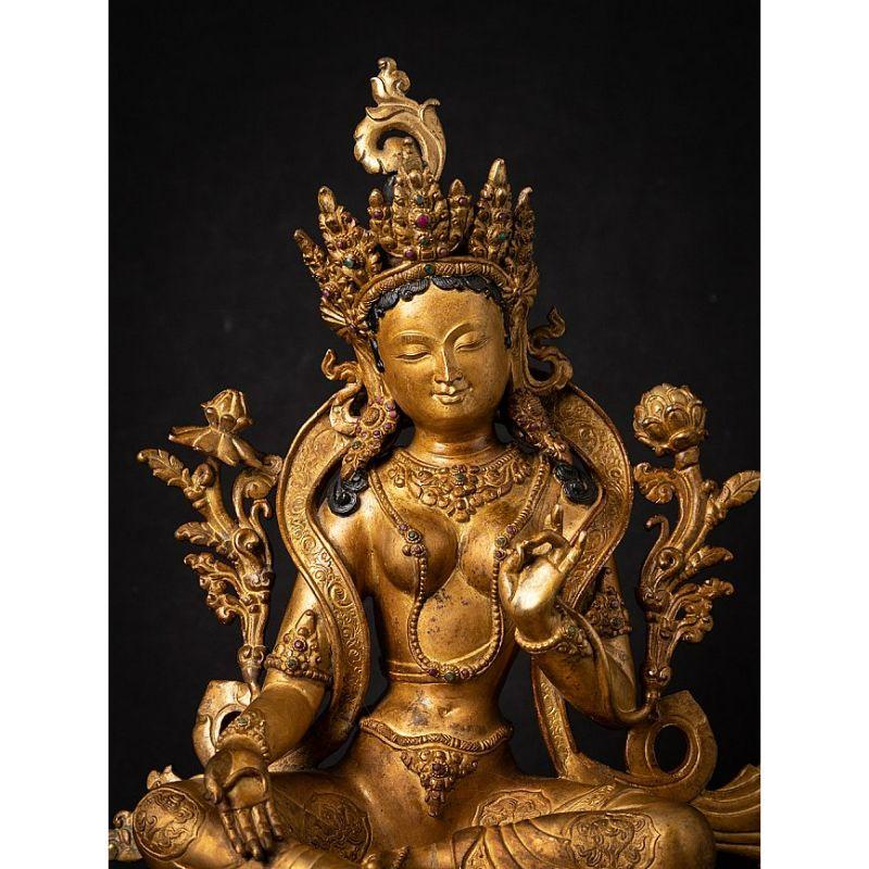 Material: bronze
Measures: 38,5 cm high 
29 cm wide and 24,5 cm deep
Weight: 6.371 kgs
Fire gilded with 24 krt. gold
Originating from Nepal
Middle 20th century
With inlayed gem stones
Very high quality !

