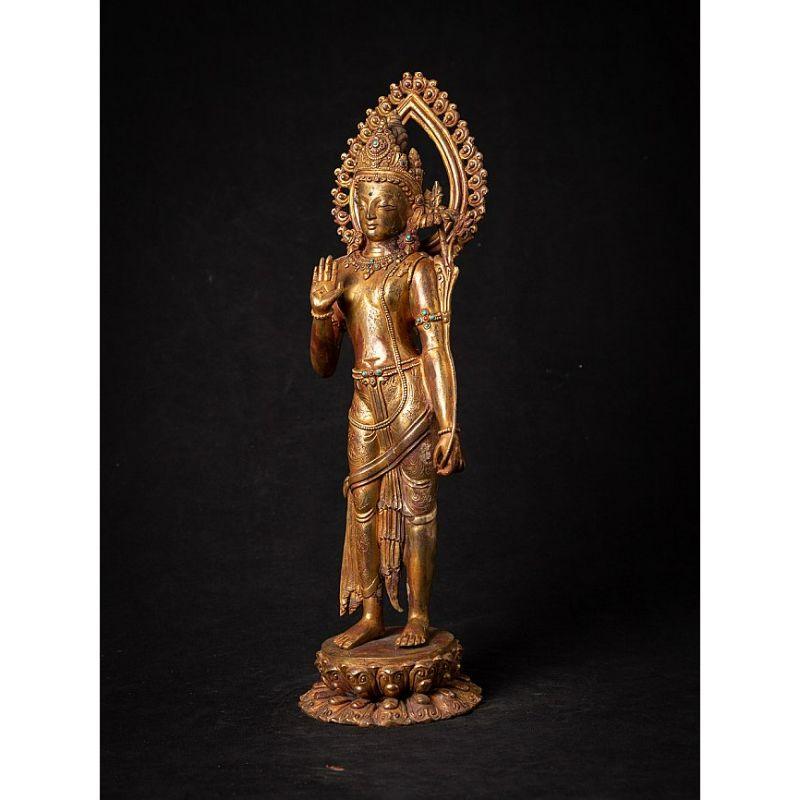 Material: bronze
42,2 cm high 
12,3 cm wide and 12 cm deep
Weight: 3.943 kgs
Fire gilded with 24 krt. gold
Abhaya mudra
Originating from Nepal
Middle 20th century
Inlayed with gem stones
High quality !
 